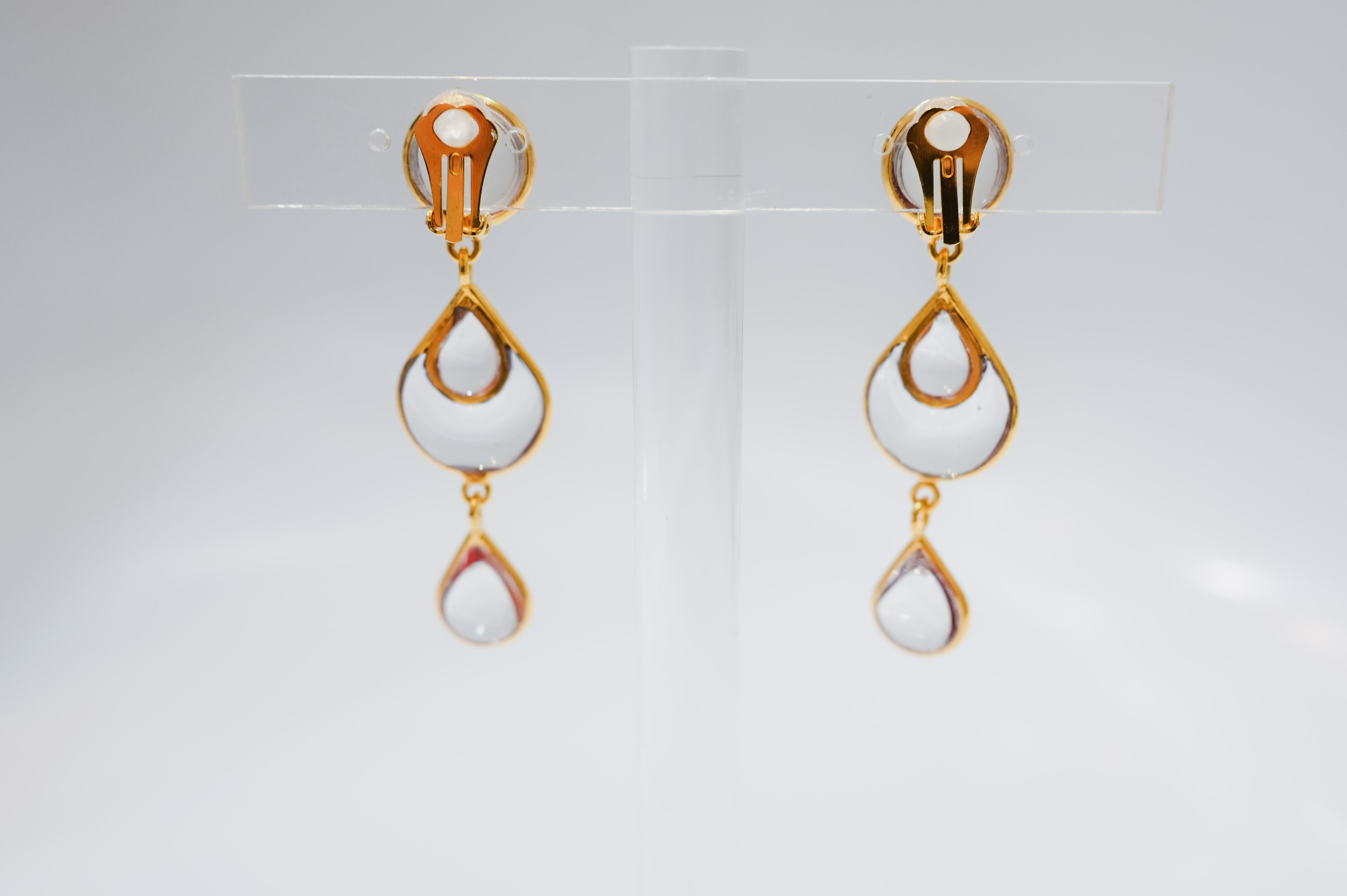Design by Françoise Montague. Gripoix work by former artisans of the atelier. Clip earrings Gripoix work ( famed pate de verre  for the House of Chanel) was used for these oval shaped drop earrings. Poured glass in clear, gilded brass 

Francoise