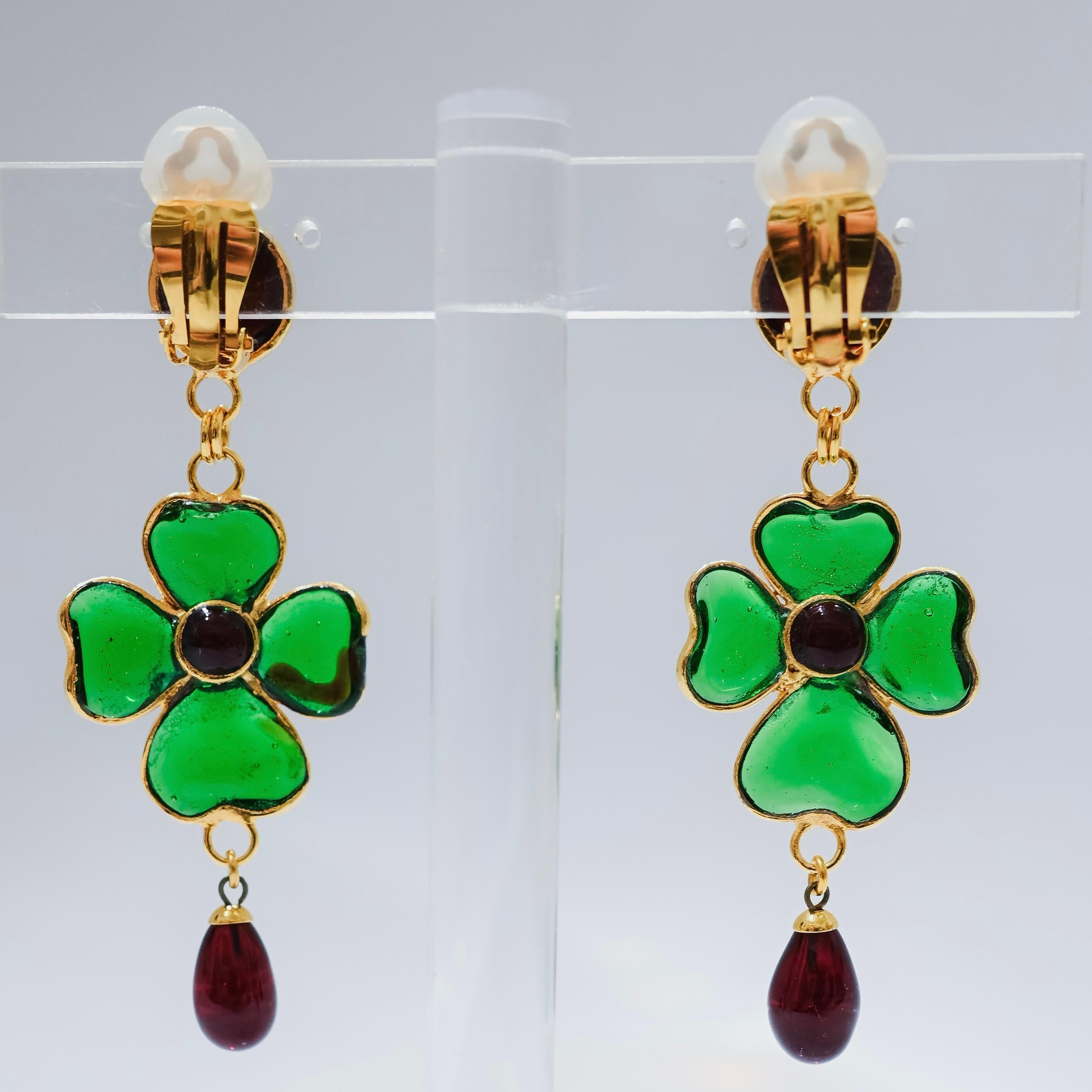 Design by Françoise Montague. Gripoix work by former artisans of the atelier. Clip earrings Gripoix work ( famed pate de verre  for the House of Chanel) was used for these clover drop earrings. Poured glass in emerald green and red, gilded brass