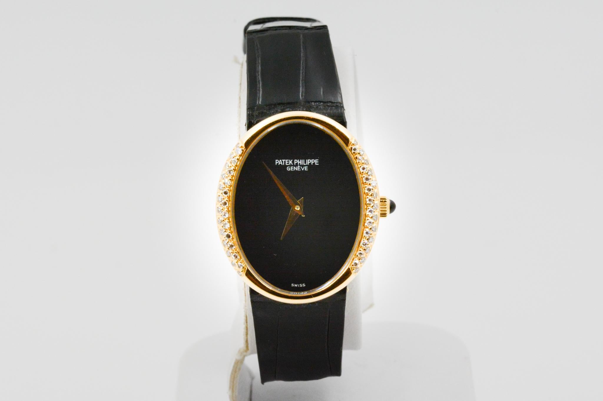 Model: Patek Philippe Golden Ellipse Ladies Watch Oval Case
Movement: Manual Wind
Case Size: 24.9x29mm Oval Case 18k Yellow Gold
Dial: Black Enamel, Sides feature 50 round single cut diamonds
Strap: 15mm Black Alligator with Tang Buckle
Circa 2000s