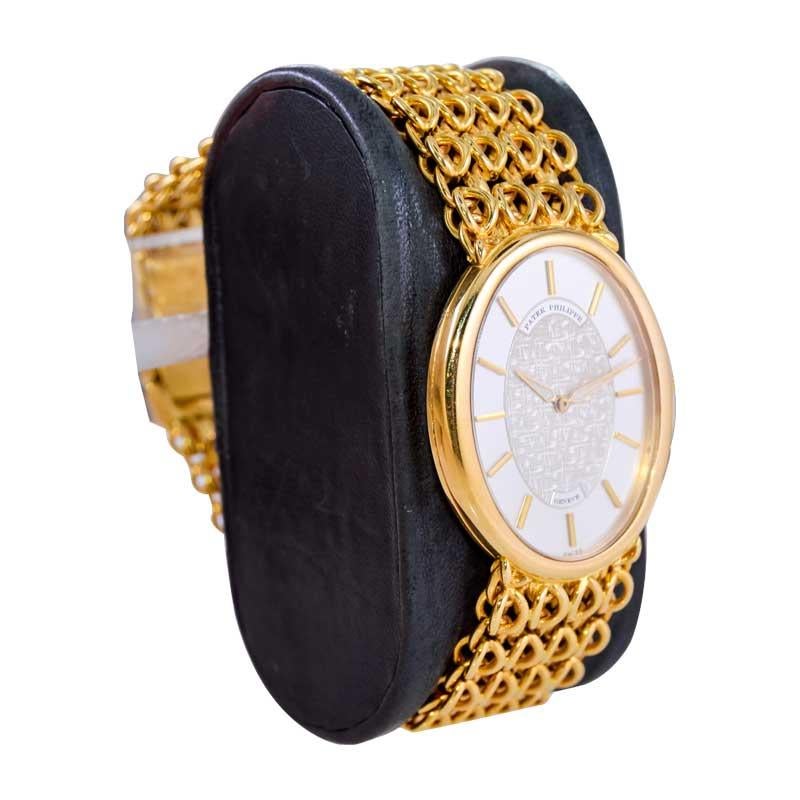 FACTORY / HOUSE: Patek Philippe & Cie.
STYLE / REFERENCE: Men's Oval Bracelet Watch
METAL / MATERIAL: 18kt Yellow Gold
CIRCA: 1973
DIMENSIONS: Length 35mm X Diameter 30mm
MOVEMENT / CALIBER: 18 Jewels / Cal. 16-250
DIAL / HANDS: Original Gold Dial