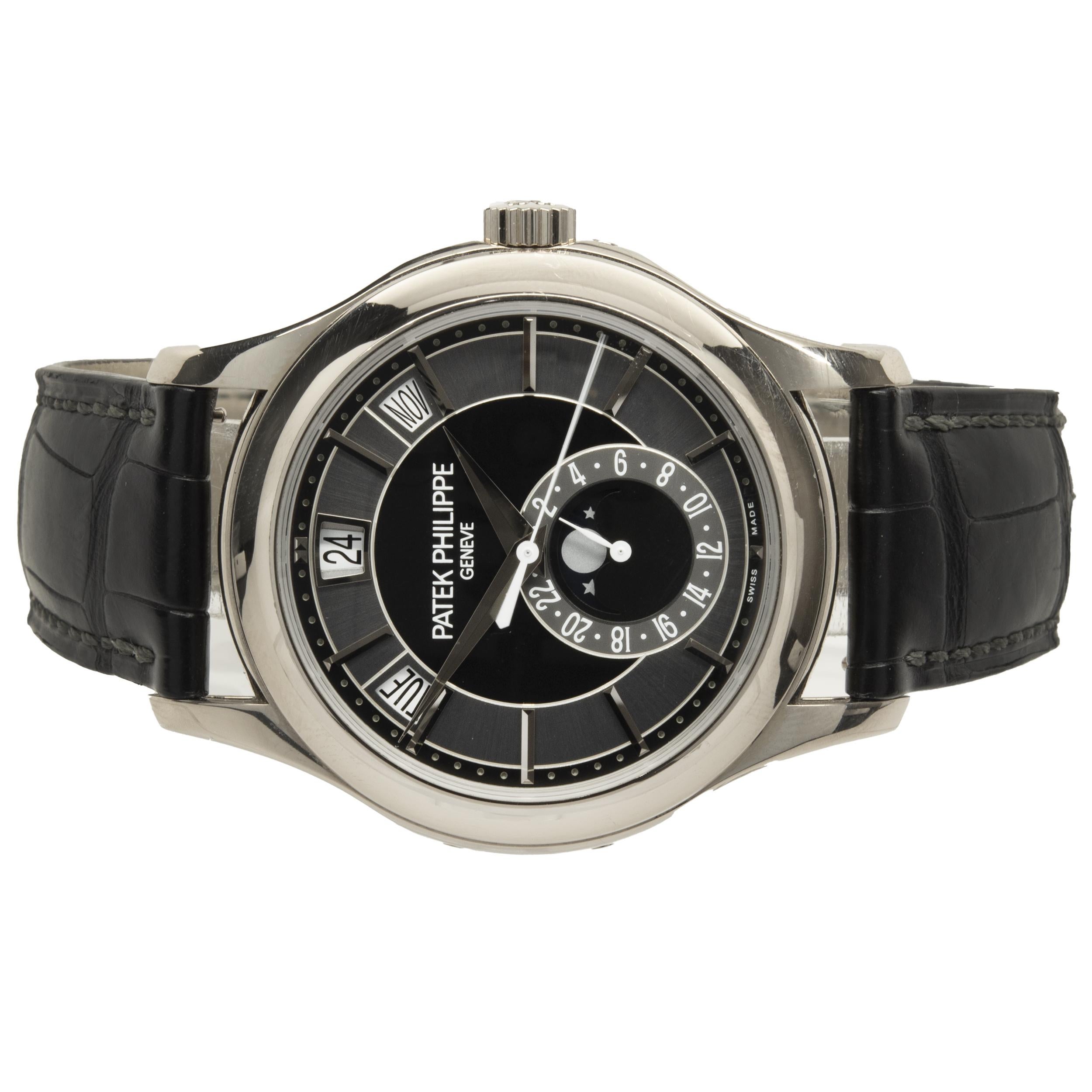 Movement: automatic
Function: hours, minutes, seconds, day, date, month, moonphase 
Case: 40mm 18K white gold case, smooth bezel, sapphire crystal, push pull crown
Band: black alligator strap, 18K white gold Patek buckle
Dial: Black sunburst, black
