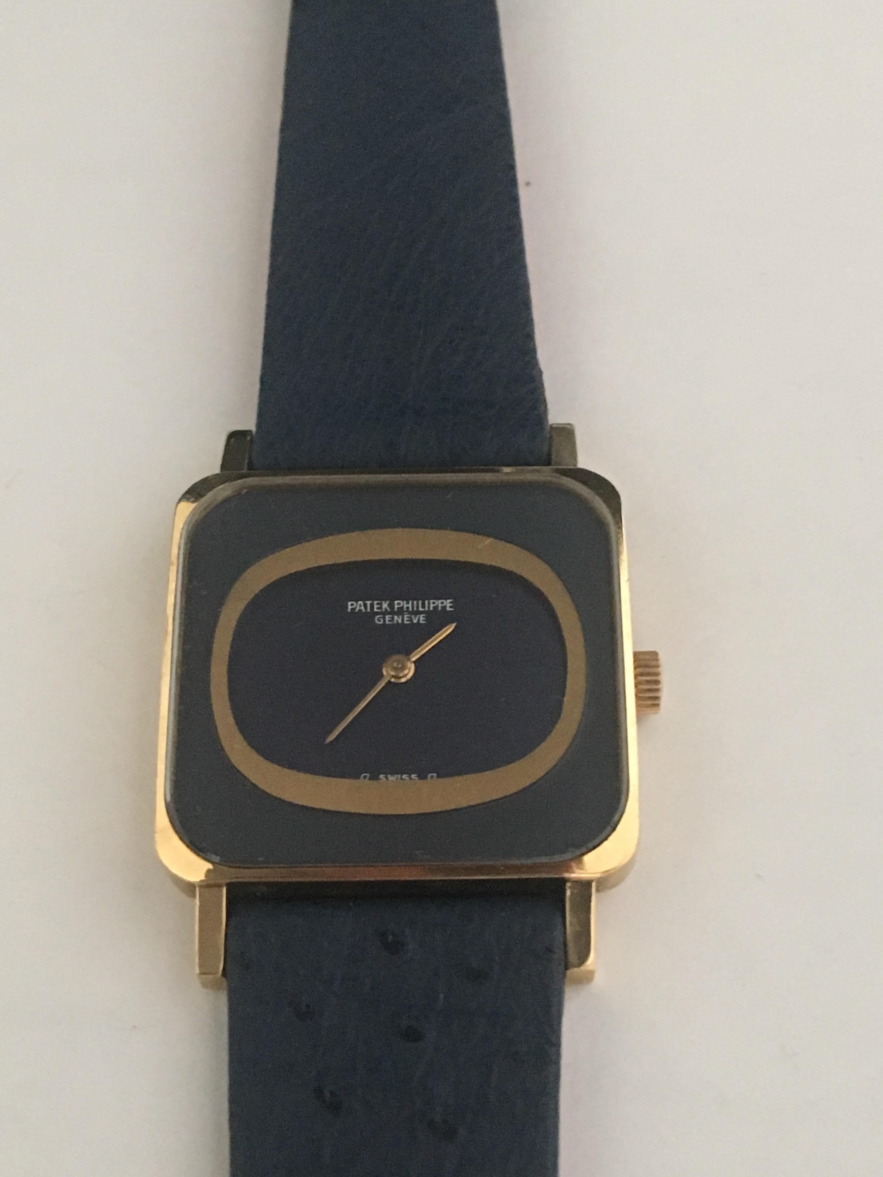 Patek Philippe 18k Yellow Gold Ellipse manual wind with a dark sapphire dial, sapphire crystal and a Corum sapphire ostrich strap with original box, in excellent condition.