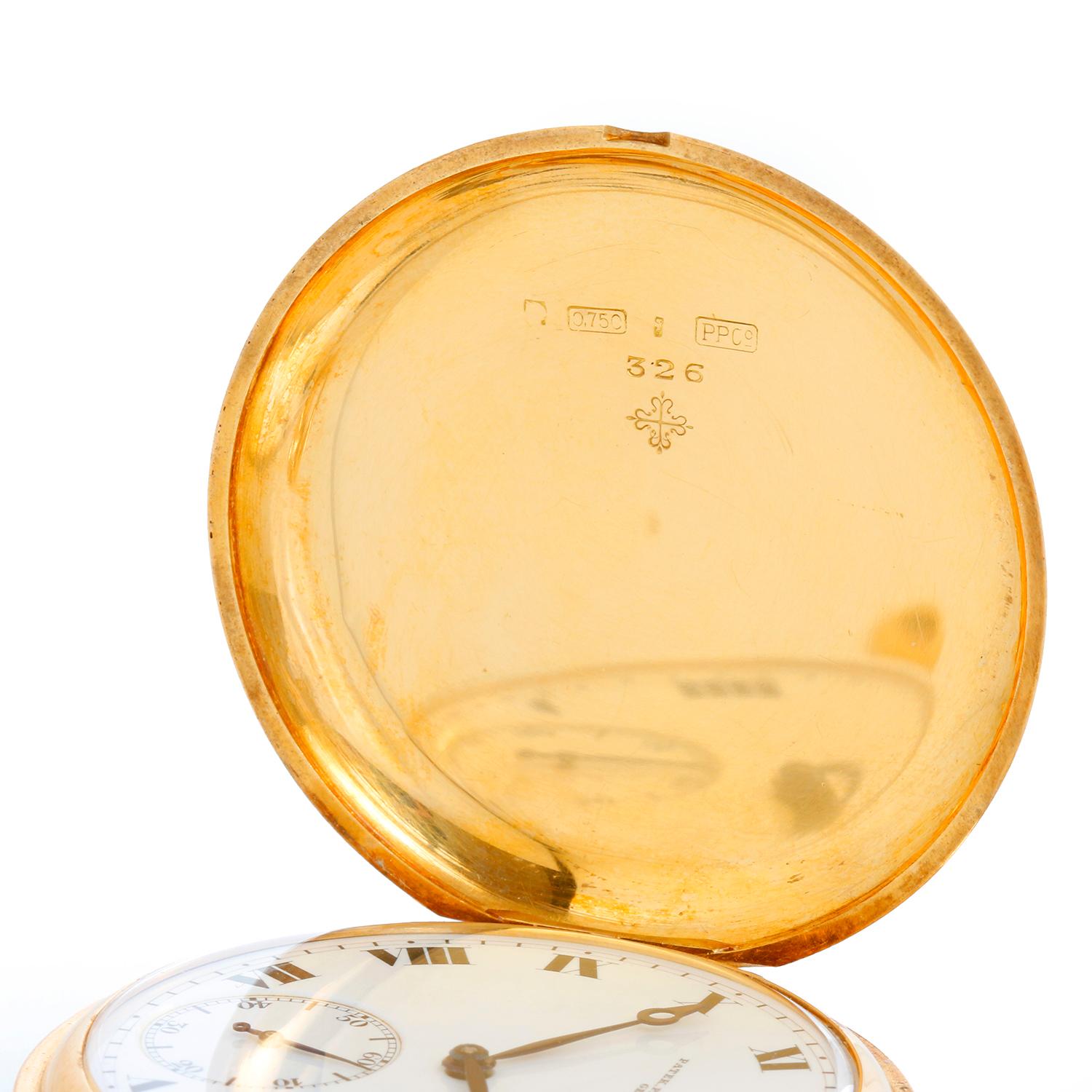 Patek Philippe 18K Hunting Case Roman Numerals Pocket Watch - Manual winding. 18K Yellow Gold case (45 mm). White dial with black Roman numerals sub seconds at 6 o'clock position; blue hands. Case & dial are signed. Pre-owned with custom box.