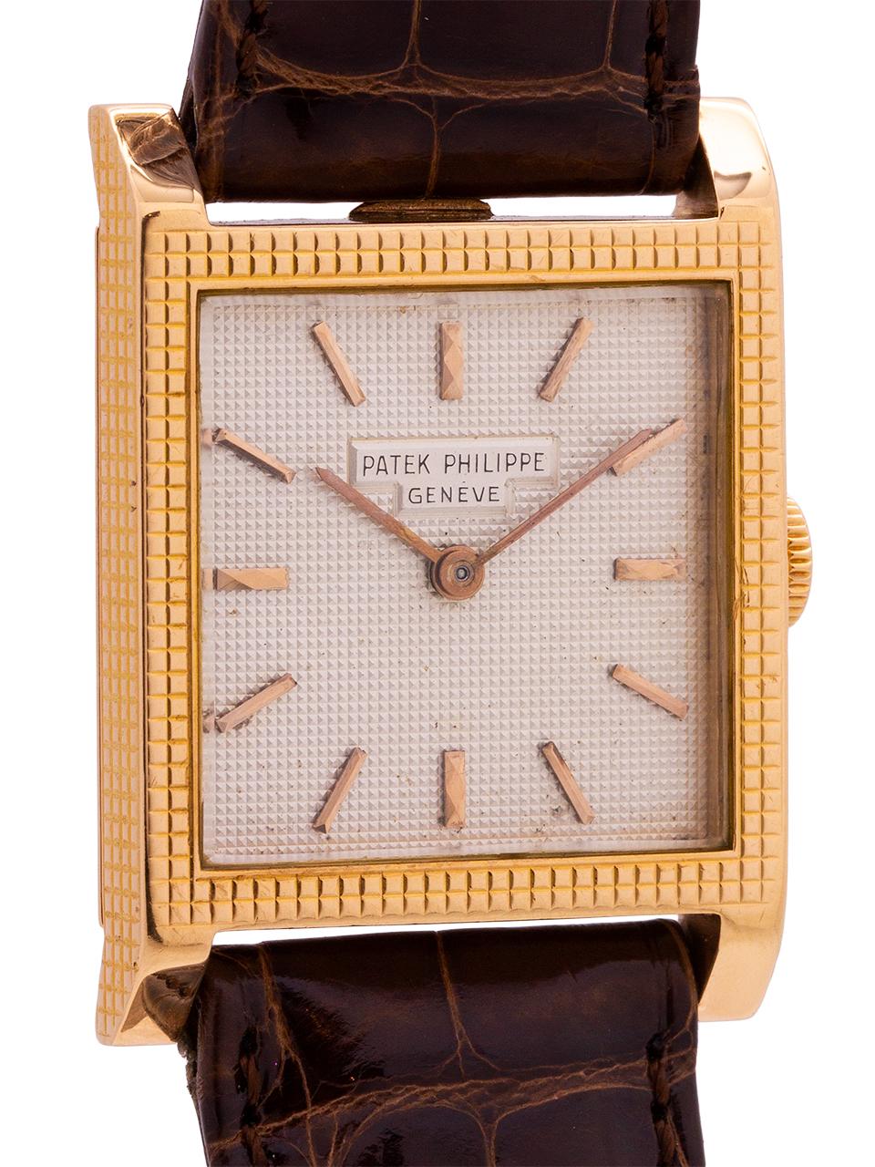 
A very attractive vintage Patek 18K pink gold square shaped dress model 25 x 34mm case with waffle textured bezel and original silver textured dial, applied pink indexes and pink baton hands circa 1969. The dial is entirely in synch with the