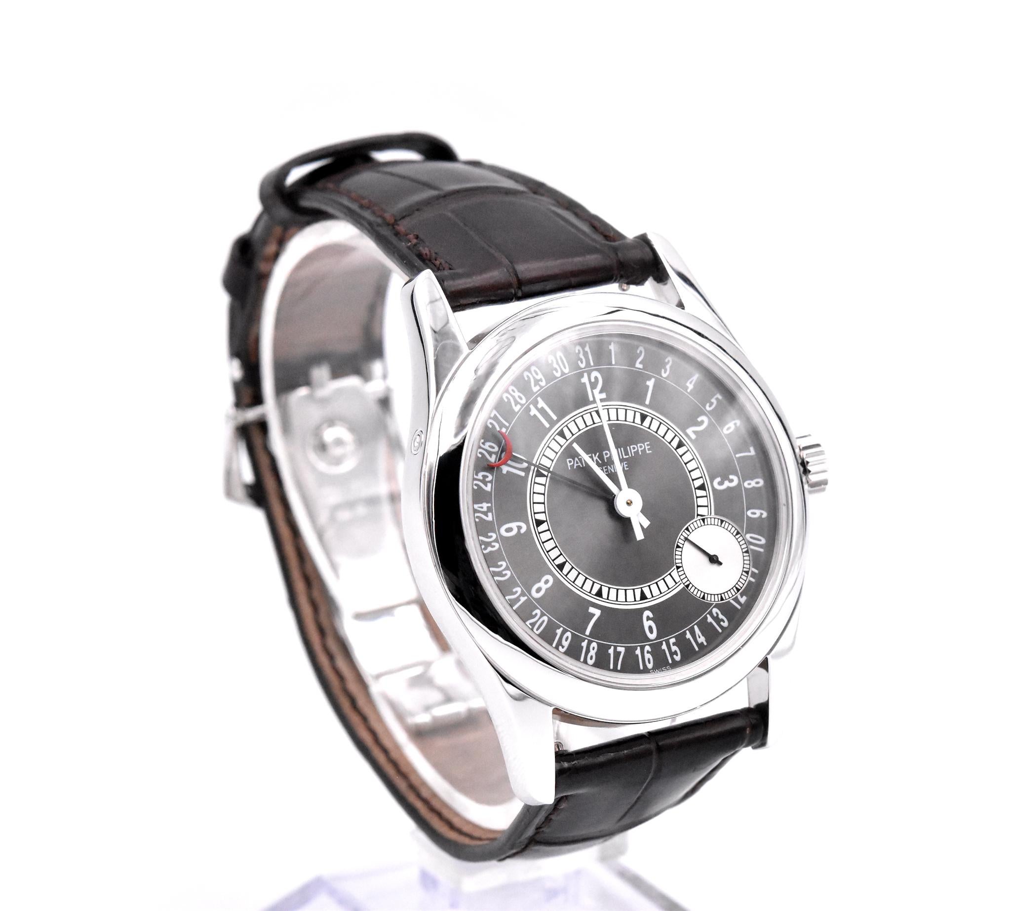 Movement: automatic caliber 240/166
Function: hours, minutes, seconds, date
Case: 37mm white gold case, sapphire protective crystal, push/pull crown
Dial: grey dial with large red crescent hand for date, offset small seconds sub-dial
Band: factory