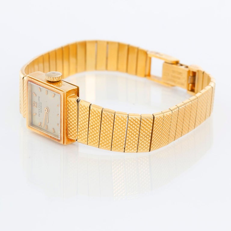 Patek Philippe 18K Yellow Gold Ladies Watch Ref 3293 - Manual winding. 18K Yellow gold ( 15mm). Silver dial with stick hour markers. 18k yellow gold Patek Philippe bracelet with clasp; will fit a 6 1/2 inch wrist. Pre-owned with custom box. 