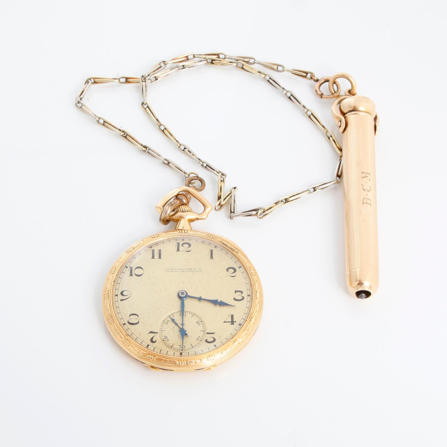 Patek Philippe 18K Yellow Gold Pocket Watch with Pencil & Chain  - Manual winding. 18K Yellow Gold Case engraved with blue enamel  ( 44 mm ). Champagne dial with Arabic numerals and subdial at 6 o'clock. Comes with a 13 inch chain, that is attached