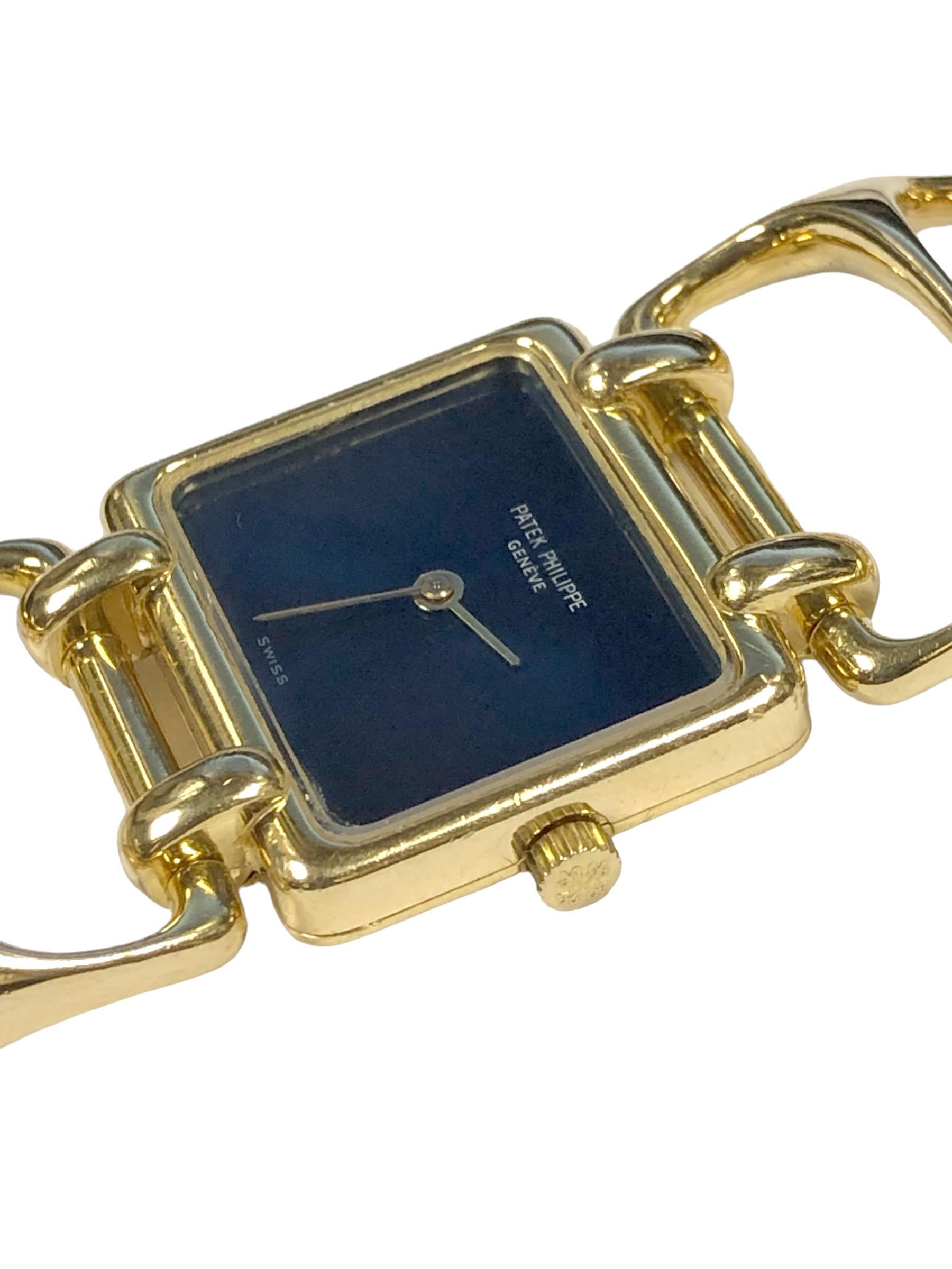 Circa 1970s Patek Philippe Reference 4237 / 1  18k Yellow Gold Bracelet Watch, 25 x 21 M.M 2 Piece case, 18 Jewel Nickle Lever Mechanical, manual wind movement, Blue Satin dial, Glass Crystal and Patek logo Crown. 1 inch wide Modernistic style
