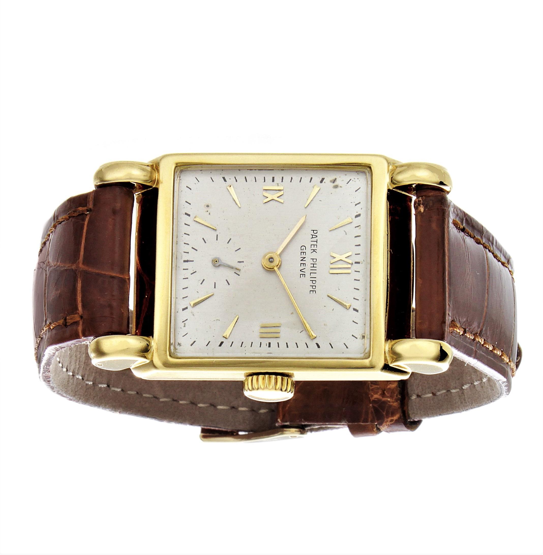 Introduction:
 Patek Philippe 2435J rectangular shaped 18K yellow gold watch, made in 1948.  The watch measures 25 x 40mm.  The case design is with a flared case with large half round lugs, silver dial with raised gold roman numerals and indices. 