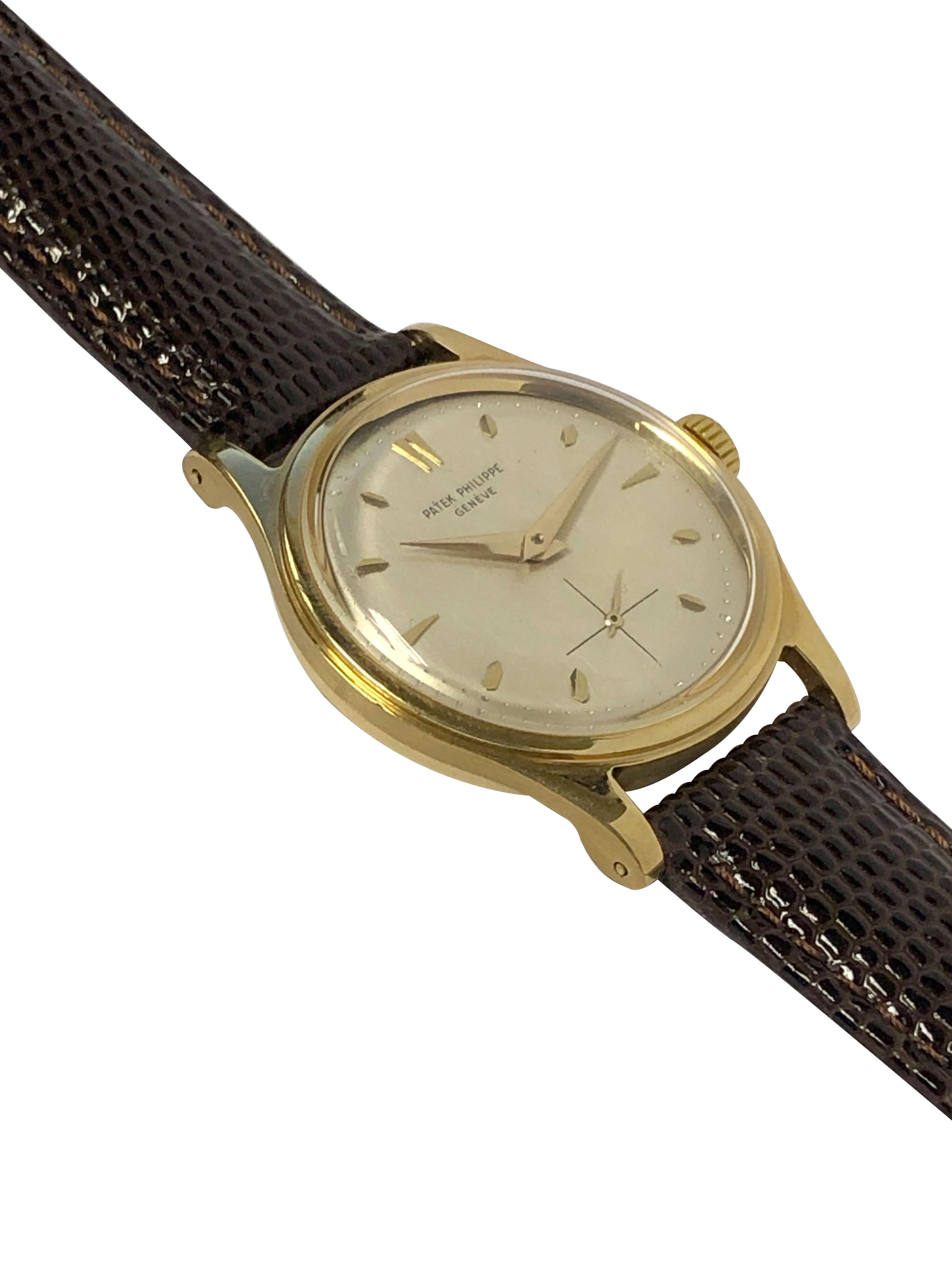 Circa mid 1950s Patek Philippe Reference 2509 Wrist Watch, 35 M.M x 9 M.M thick 18k Yellow Gold Waterproof case with inside dust cover. Caliber 12-400 Gold lever 18 Jewel mechanical, Manual wind movement. Silver Satin Dial with raised Gold markers