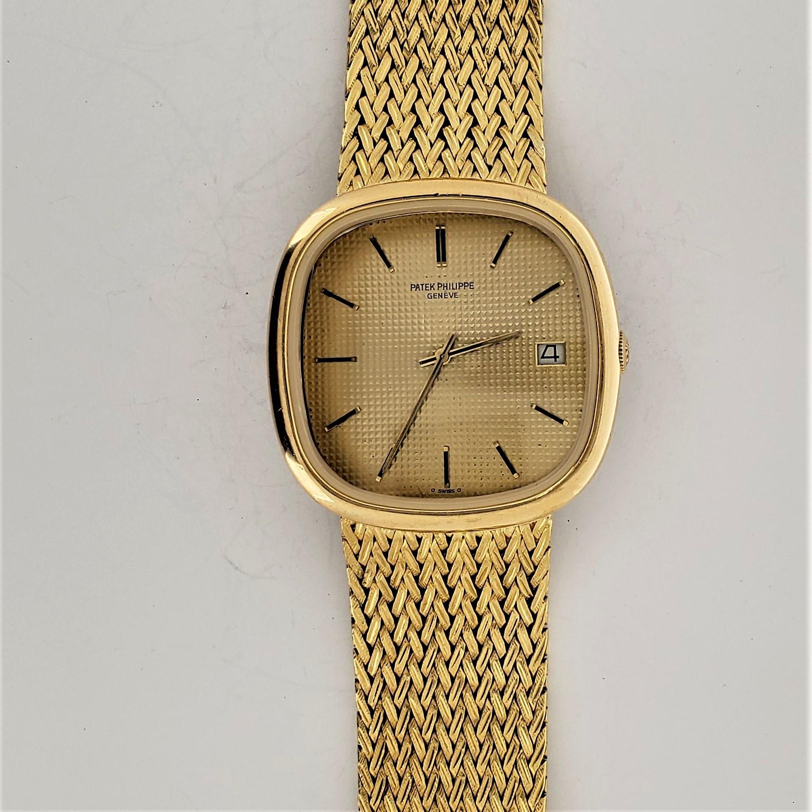 Patek Philippe 3604/2 Cushion shape Automatic winding 18 karat gold bracelet watch,  The watch measures 36 x 35 mm with a attached Patek herringbone pattern bracelet measuring 8 inches long (20 cm).  The dial has a hobnail design and is made also of