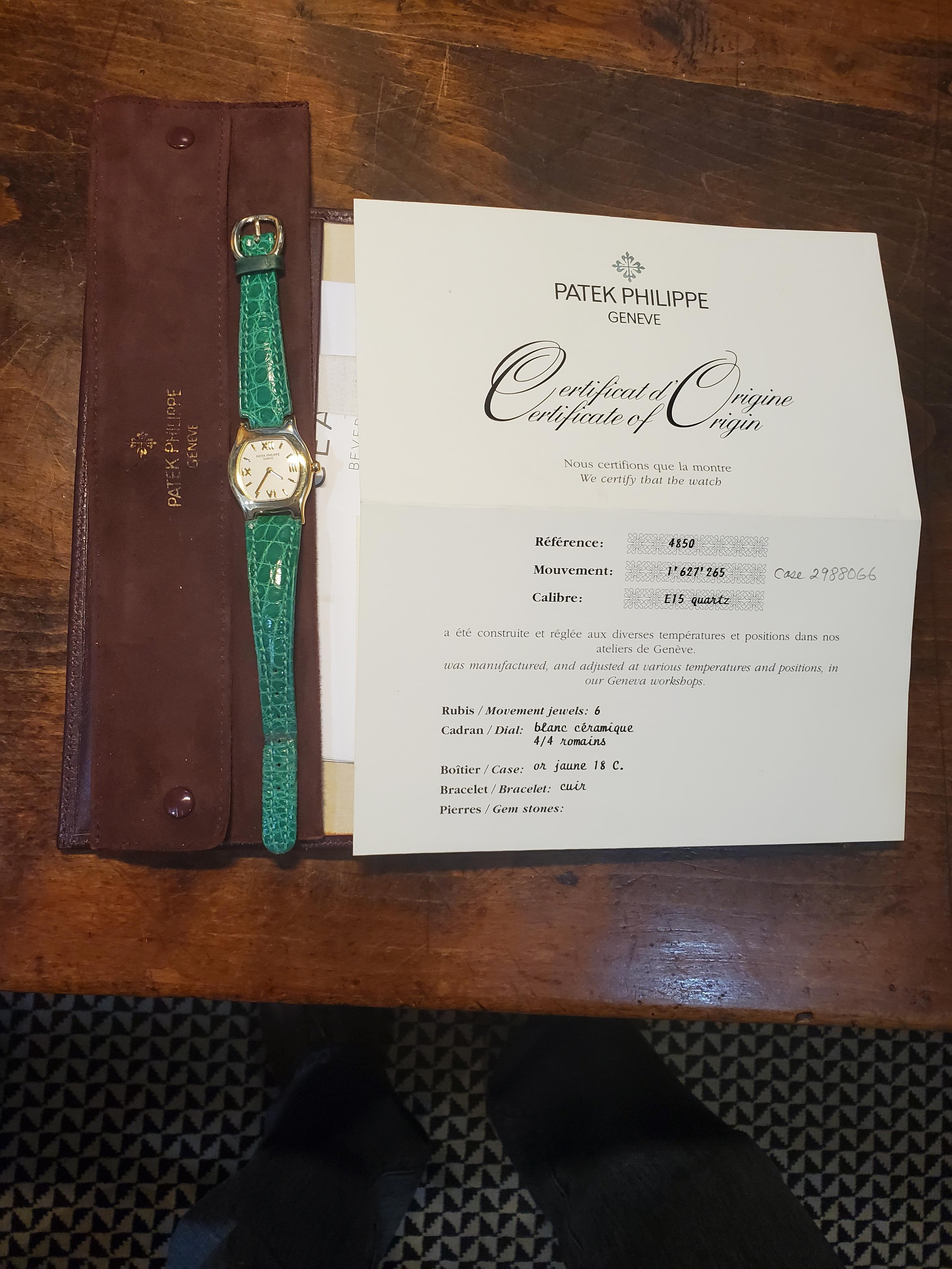 Introduction: 
Patek Philippe 4850J; Ladies Tonneau cushion shaped watch.  The watch is made in 18K yellow gold, in a Tonneau  (Barrel) shaped case.  The watch was made in 1997, and is fitted with a E-15 Caliber 6-jewel movement # 1627265, case#