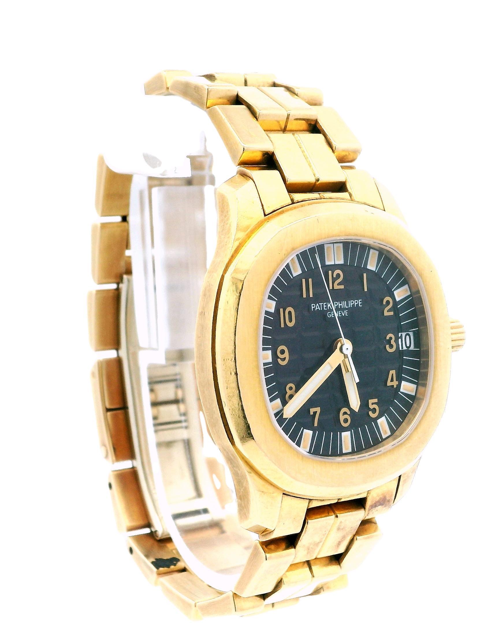 Patek Philippe Aquanaut Jumbo 5065/1 Men's Watch. This watch features a 38mm case crafted from 18K yellow gold, complemented by an octagonal 18K yellow gold bezel. The black dial is adorned with luminous gold hands, along with index and Arabic