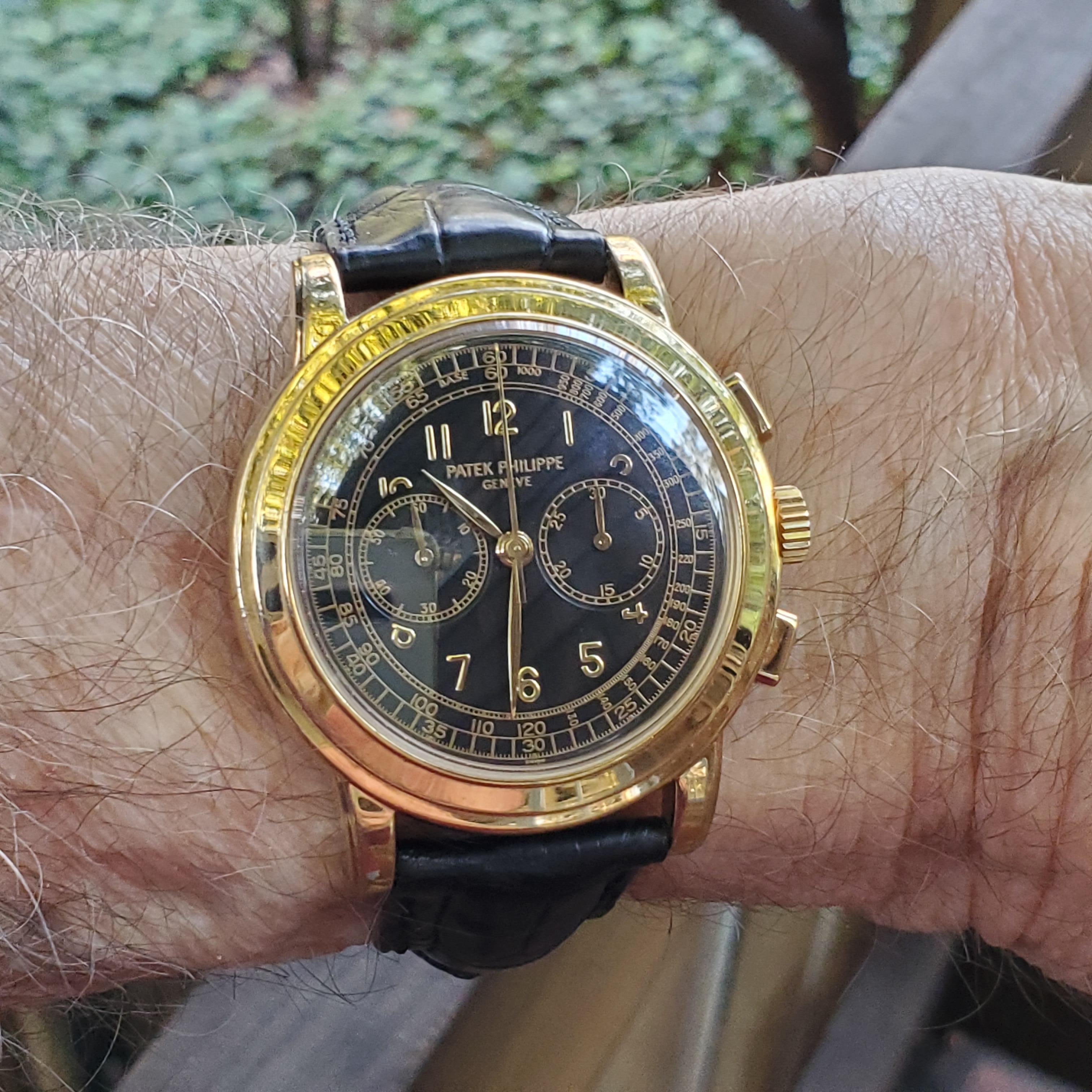 Patek Philippe Ref# 5070J-001  This example is in excellent condition with very crisp hallmarks.

The 5070J chronograph manual-wind watch, features a 42 mm case. This is a Yellow gold example with Black dial and yellow gold deployment buckle.