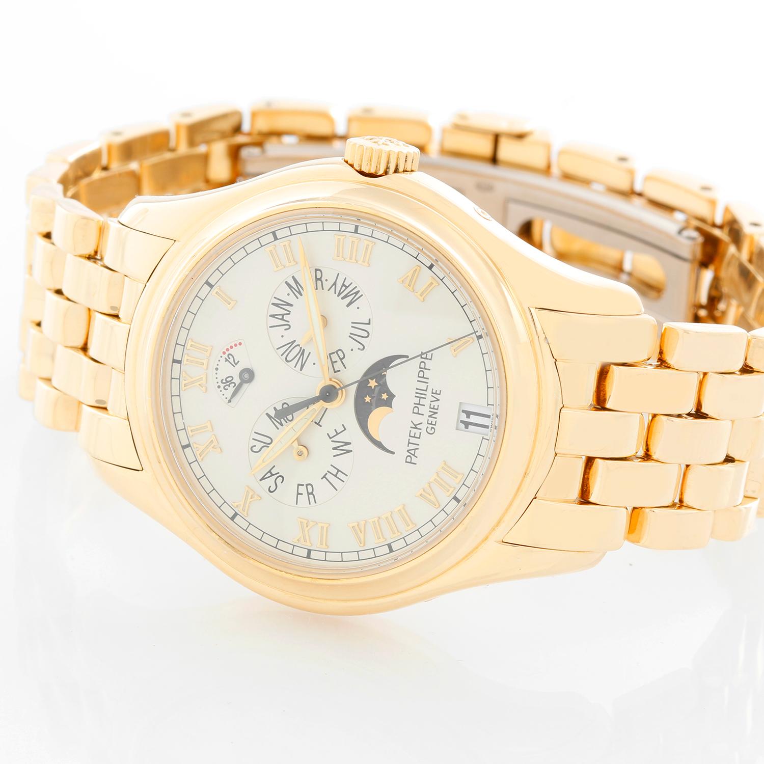 Patek Philippe Annual Calendar Men's 18k Yellow Gold Moonphase Watch 5036J (or 5036) -  Automatic winding with 18k gold rotor. 18k yellow gold with exposition back (36mm diameter). Silver dial with raised Roman numerals;  power reserve indicator,