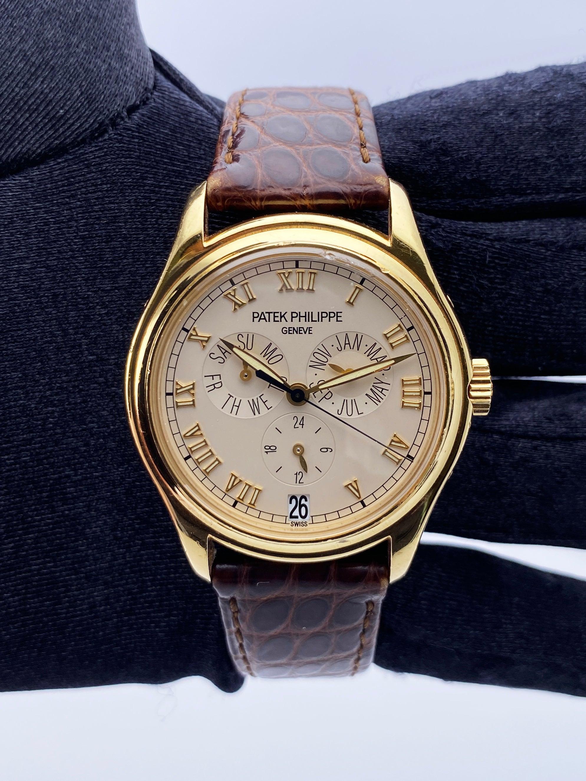 Patek Philippe Annual Calendar 5035J-011 Mens Watch. 37mm 18K yellow gold case and 18K yellow gold bezel. Cream dial with luminous gold hands and gold Roman numeral hour markers. Annual calendar. Day display at 9 o'clock. Month display at 3 o'clock.