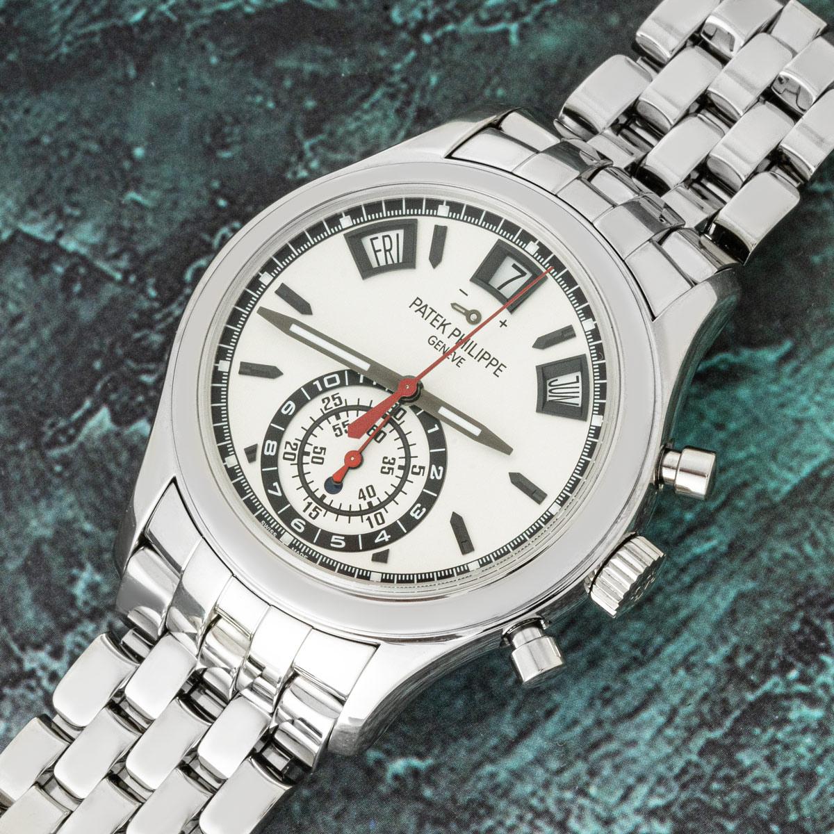 A Complications Annual Calendar Chronograph in stainless steel by Patek Philippe. Featuring a silver dial with displays of the day, date, and month. The dial also features a power reserve indicator as well as a 30 minute, 60 seconds, and 12 hour