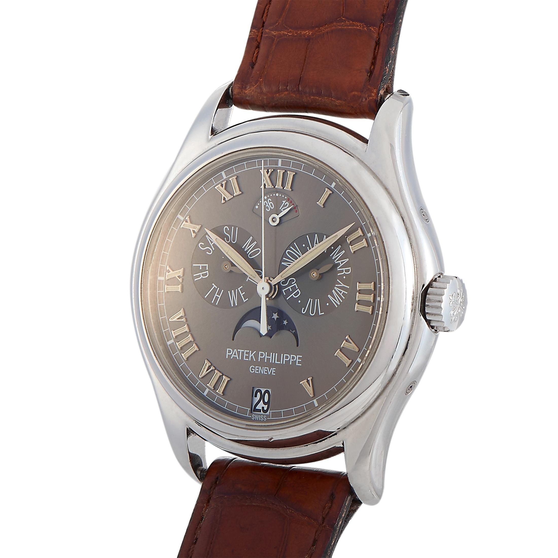 This is the Patek Philippe Annual Calendar, reference number 5056P.
 
 The watch is presented with a 37 mm platinum case that boasts see-through back. The case is mounted onto a brown leather strap fitted with a tang buckle. This model is equipped