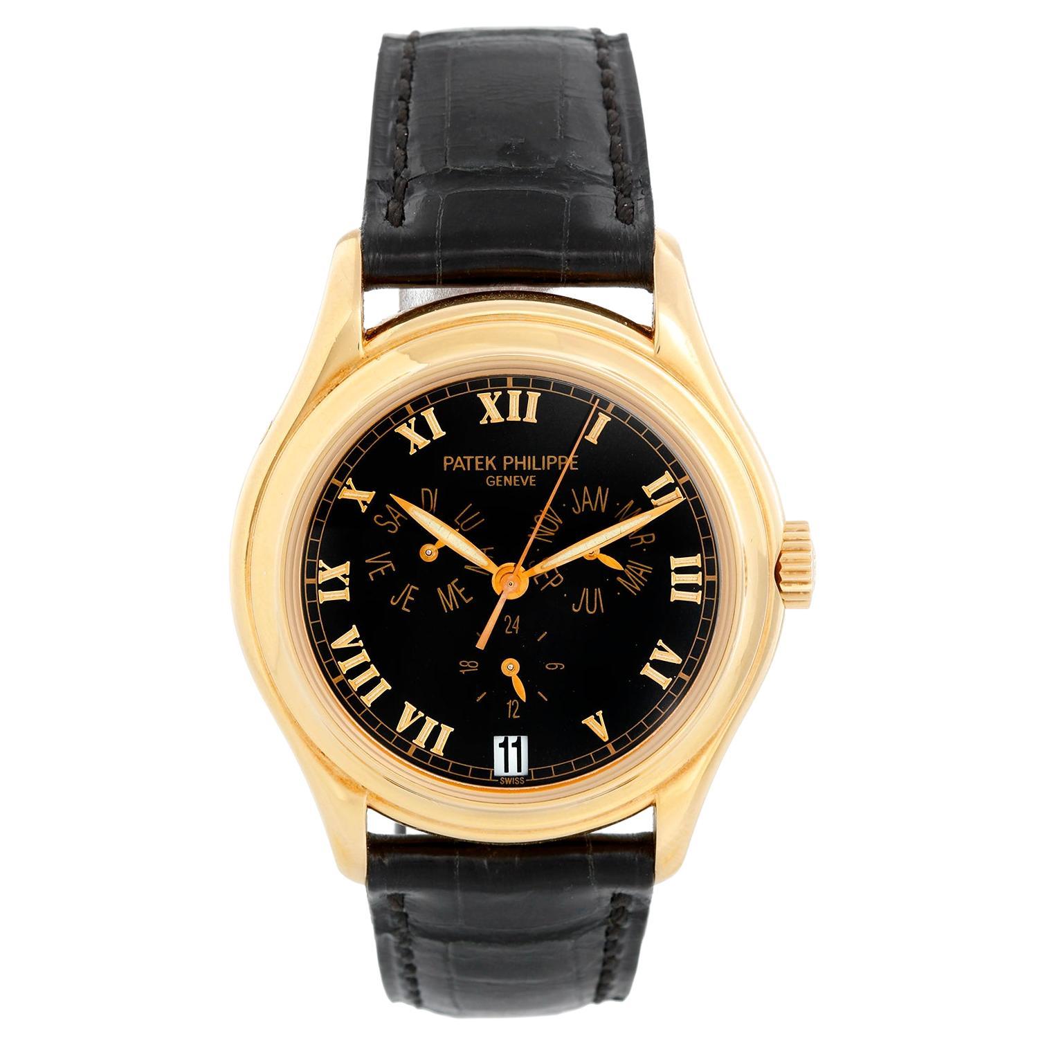Patek Philippe Annular Calendar 18k Yellow Gold Men's Watch 5035 J (or 5035j) - Automatic winding. 18K yellow gold case with exposition back to view movement (37mm diameter). Black dial with raised gold Roman numerals; triple calendar & 24 hour