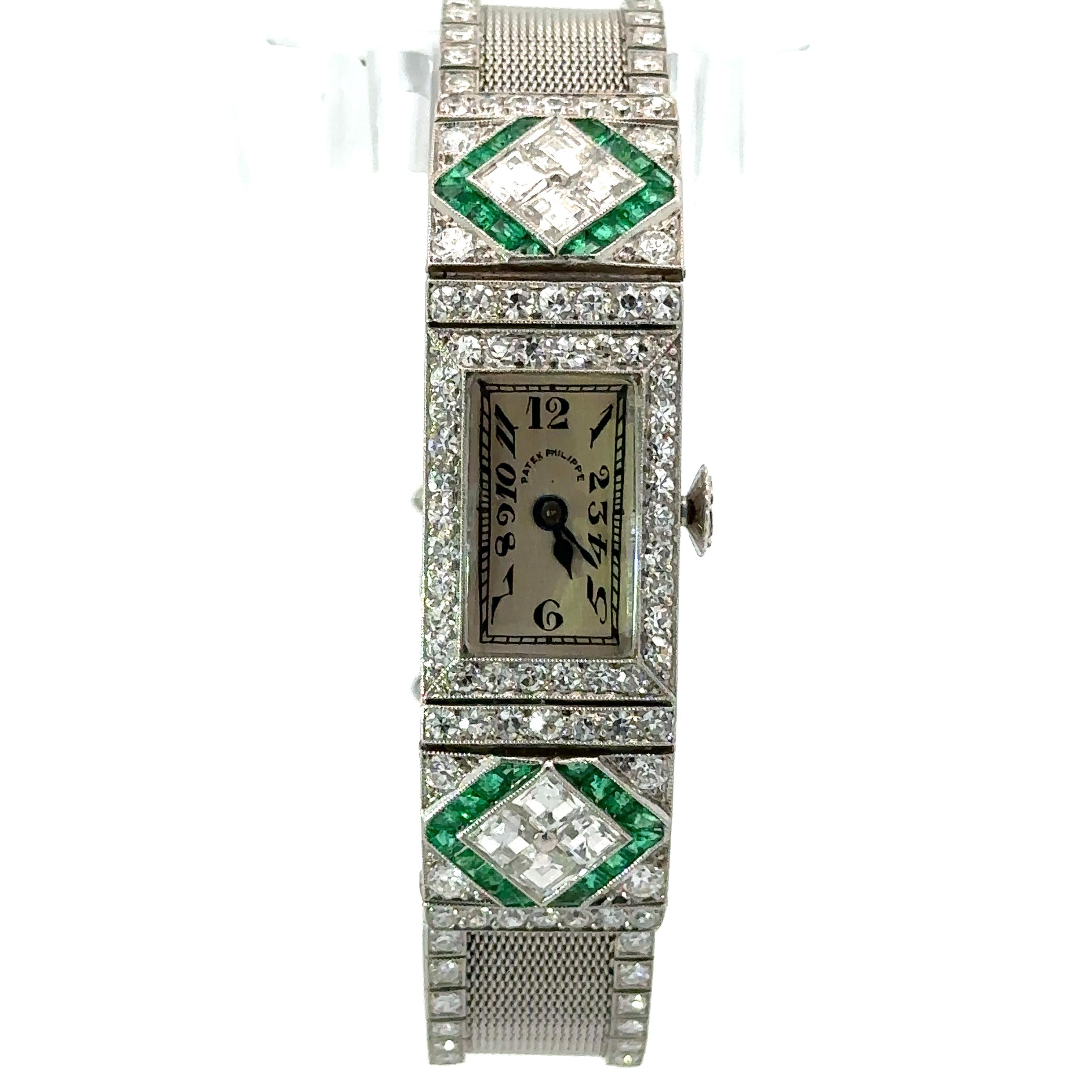 This fancy antique ladies wrist watch was crafted during the art deco period and  features a mechanical, hand winding, Swiss movement made by PATEK Philippe. Only the finest quality calibre cut natural genuine emeralds with exceptional cut, color