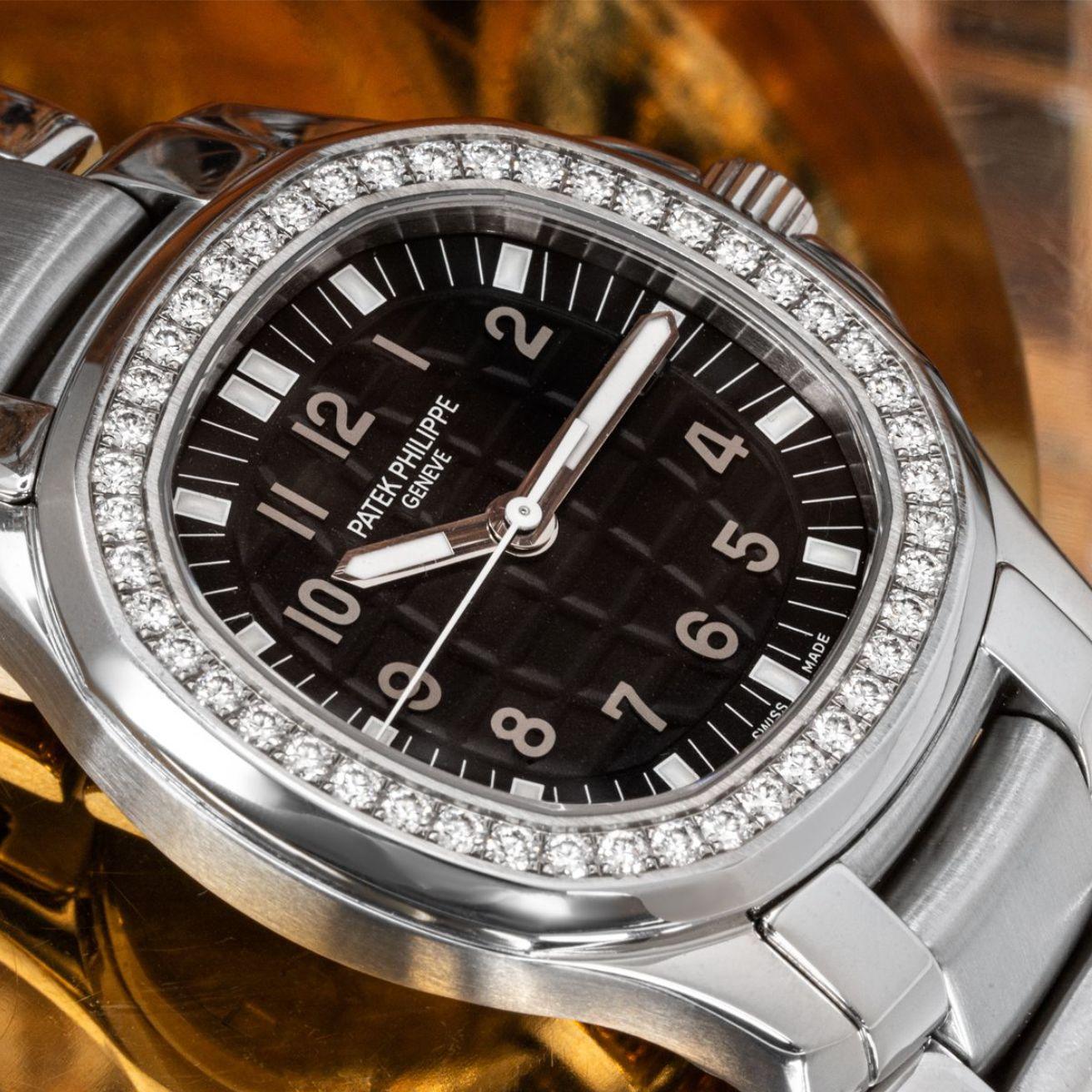 A stainless steel Aquanaut from Patek Philippe. Features a black embossed dial with a date aperture and a stainless steel bezel set with 46 round brilliant cut diamonds weighing 1.00ct.

This timepiece is fitted with a sapphire glass, a quartz