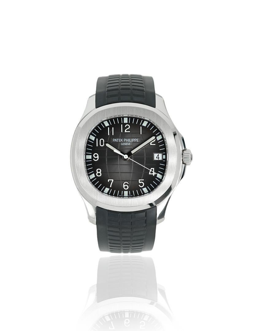 This automatic Patek Philippe Aquanaut measures 40 mm in diameter with a thickness of 8.1 mm, and it is crafted from stainless steel with a sapphire crystal case back. It features the traditional chequerboard black dial with contrasting white minute
