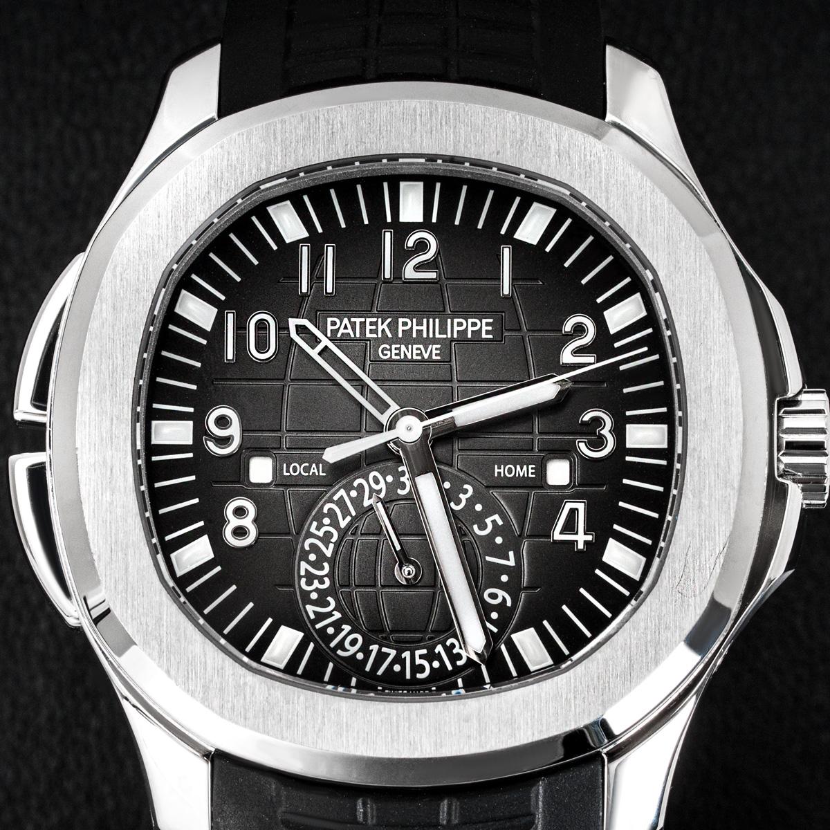 A stainless steel unworn Aquanaut Travel Time by Patek Philippe. The black dial embossed with the Aquanaut pattern features a date wheel, a second time zone hand and day/night indicators, which are covered by sapphire crystal.

The composite strap