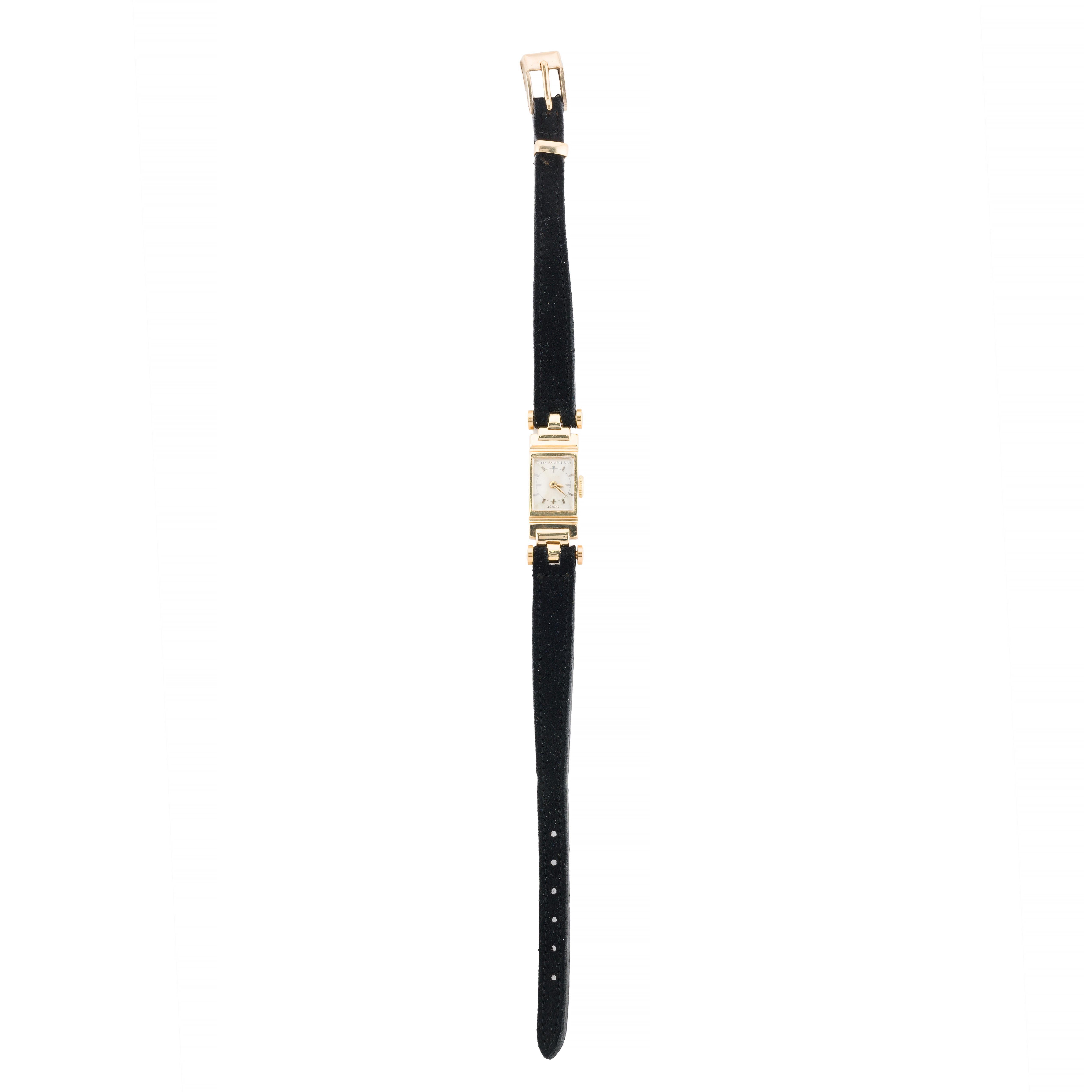 Aston Estate Jewelry Presents:

A distinguished Patek Philippe wristwatch crafted in 18k yellow gold with a sophisticated black strap.  Featuring a rare and unusual elongated and articulated case with unique round lugs.

The rectangular watch