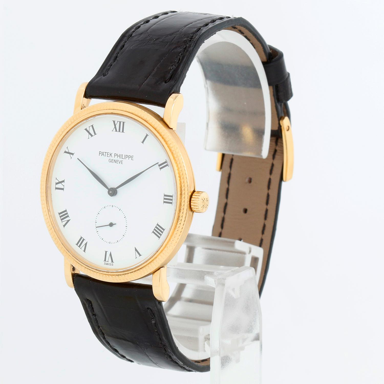 Patek Philippe Calatrava 18k Rose Gold Men's Manual Winding Watch  3919 R (or 3919R) - Manual winding. 18k rose gold case with hobnail bezel (33mm diameter). White dial with black Roman numerals. Black Patek Philippe strap band with 18k rose gold