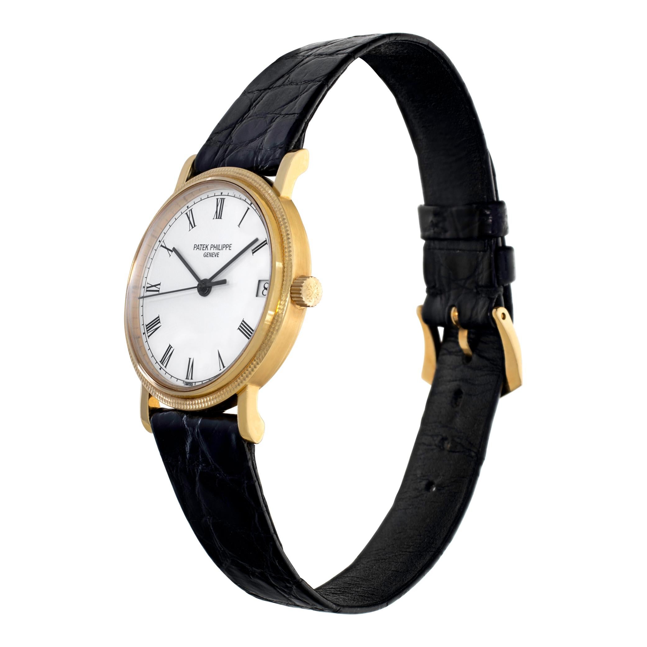 Patek Philippe Calatrava in 18k yellow gold on a black alligator strap with an 18k yellow gold Patek Philippe tang buckle. Automatic 29 jewel movement w/ sweep seconds and date. 33 mm case size. With Archive Papers. **Bank wire only at this price**