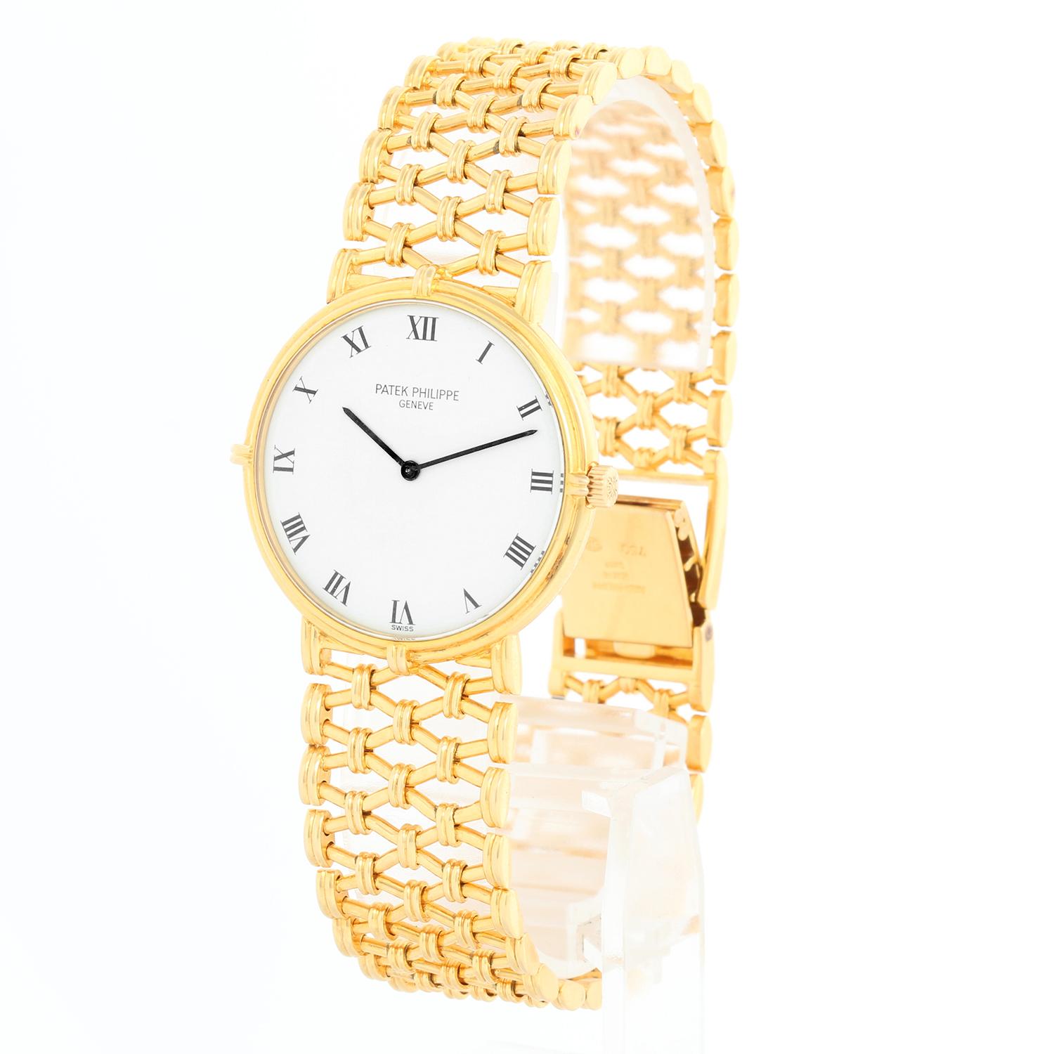 Patek Philippe Calatrava 18k Yellow Gold Men's Watch  3821/1 - Manual winding. 18k yellow gold case  (31mm diameter). White dial with black Roman numerals. Original Patek Philippe 18k Yellow Gold lattice bracelet. Pre-owned with Patek Philippe