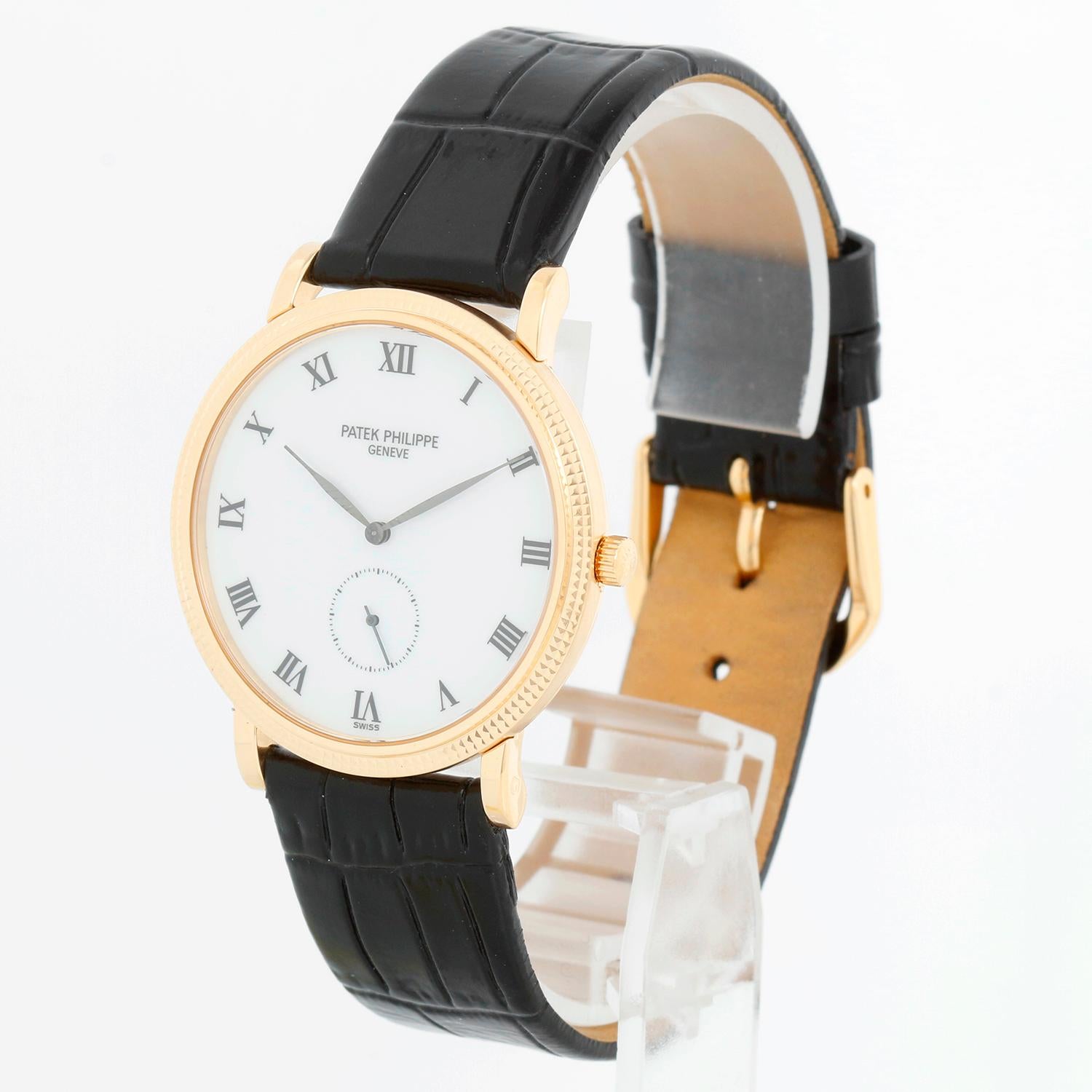 Patek Philippe Calatrava 18k Yellow Gold Men's Watch 3919 - Manual winding. 18k yellow gold case with hobnail bezel (32mm diameter). Enamel white dial with roman numerals. Black alligator strap with tang buckle . Pre-owned with Patek Philippe box
