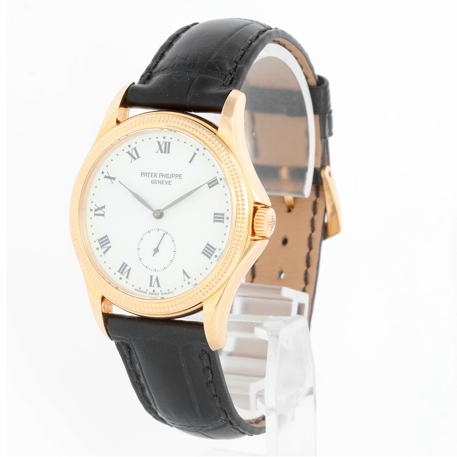 Patek Philippe Calatrava 18k Yellow Gold Men's Watch 5115 J (or 5115J) - Manual winding. 18k yellow gold case with hobnail bezel (35mm diameter). White dial with black Roman numerals; subseconds at 6 o'clock. Black Patek Philippe strap band and 18k