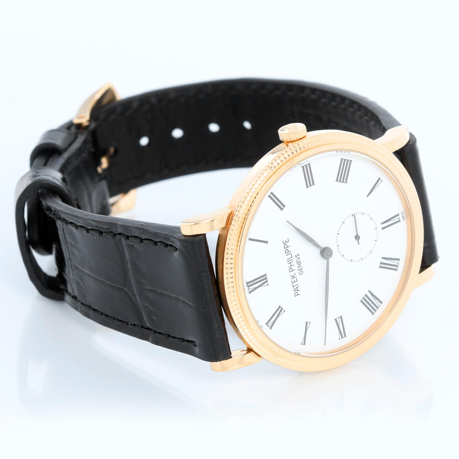 Patek Philippe Calatrava 18k Yellow Gold Men's Watch  5119-J (or 5119J-001) - Manual winding. 18k yellow gold case with hobnail bezel and exposition back (36mm diameter). White dial with black Roman numerals; subseconds at 6 o'clock. Strap band with