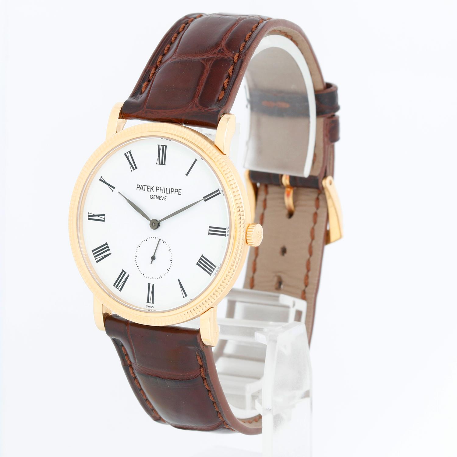 Patek Philippe Calatrava 18k Yellow Gold Men's Watch  5119-J (or 5119J-001) - Manual winding. 18k yellow gold case with hobnail bezel and exposition back (36mm diameter). White dial with black Roman numerals; subseconds at 6 o'clock. Brown Patek