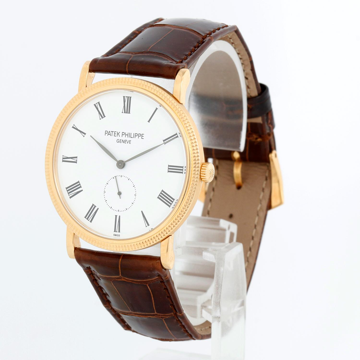 Patek Philippe Calatrava 18k Yellow Gold Men's Watch  5119-J (or 5119J-001) - Manual winding. 18k yellow gold case with hobnail bezel and exposition back (36mm diameter). White dial with black Roman numerals; subseconds at 6 o'clock. Brown Patek