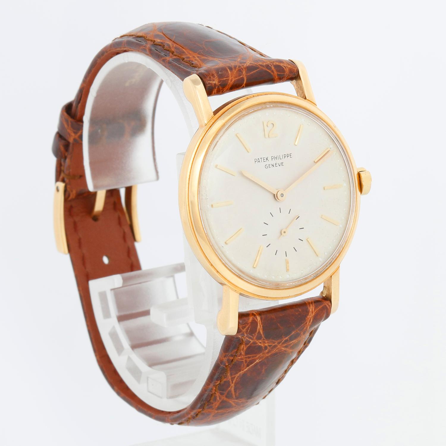 Patek Philippe Calatrava 18k Yellow Gold Men's Watch Ref. 3435 - Automatic winding. 18k yellow gold case with smooth bezel (32mm diameter) Original PP embossed crown. Silver dial with raised gold stick hour markers. Patek Philippe brown strap and