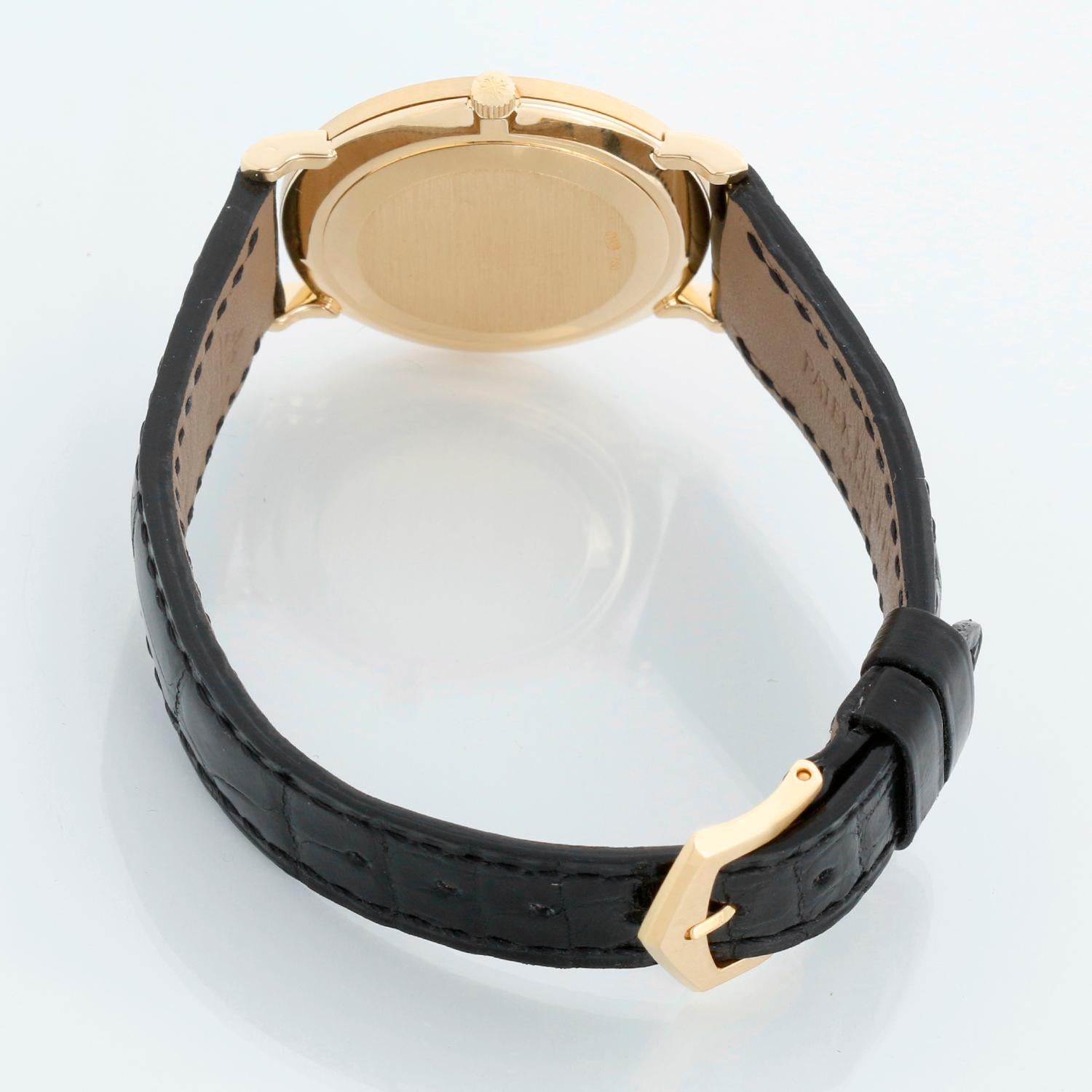Patek Philippe Calatrava Montre pour homme en or jaune 18 carats  Ref 3919 - Remontage manuel. Boîtier en or jaune 18 carats avec lunette hobnail (33 mm de diamètre). Cadran blanc avec chiffres romains noirs. Bracelet avec boucle ardillon Patek