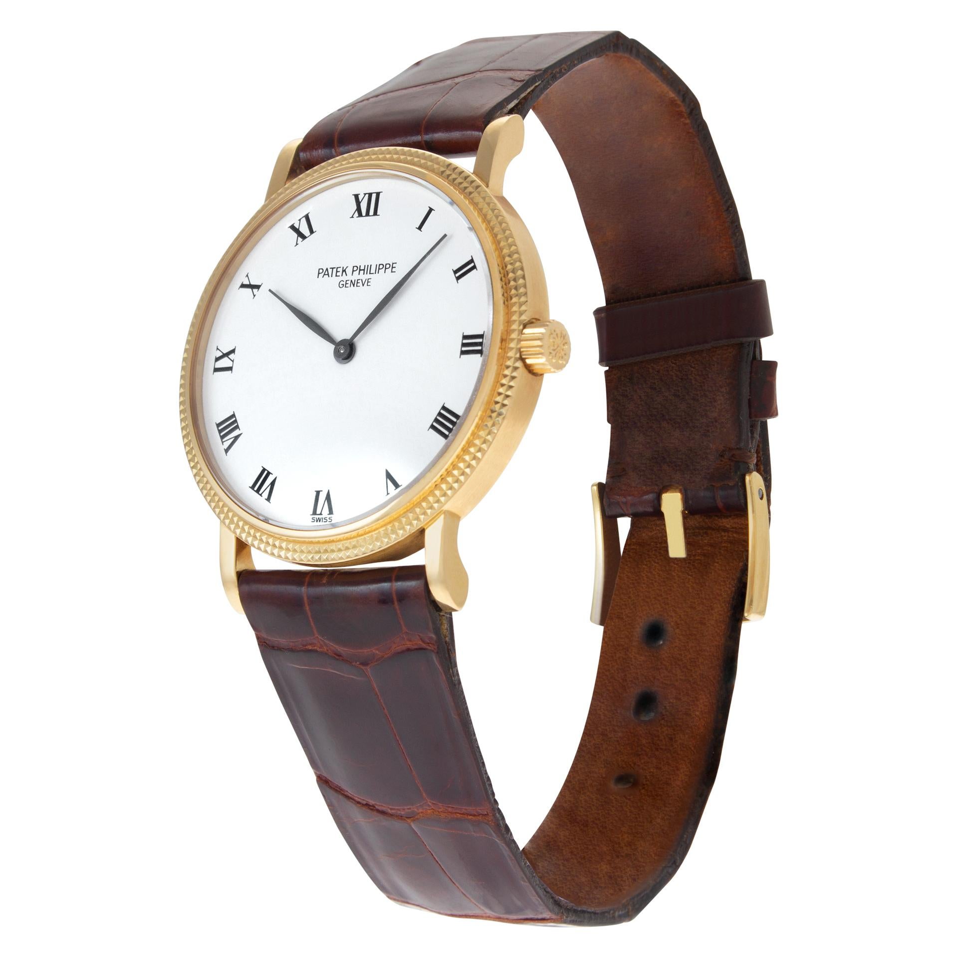 Patek Philippe Calatrava in 18k with hobnail bezel on original brown crocodile strap with Patek Philippe tang buckle. Auto. 33 mm case size. Ref 3992. Circa 1990s. Fine Pre-owned Patek Philippe Watch.

Certified preowned Dress Patek Philippe