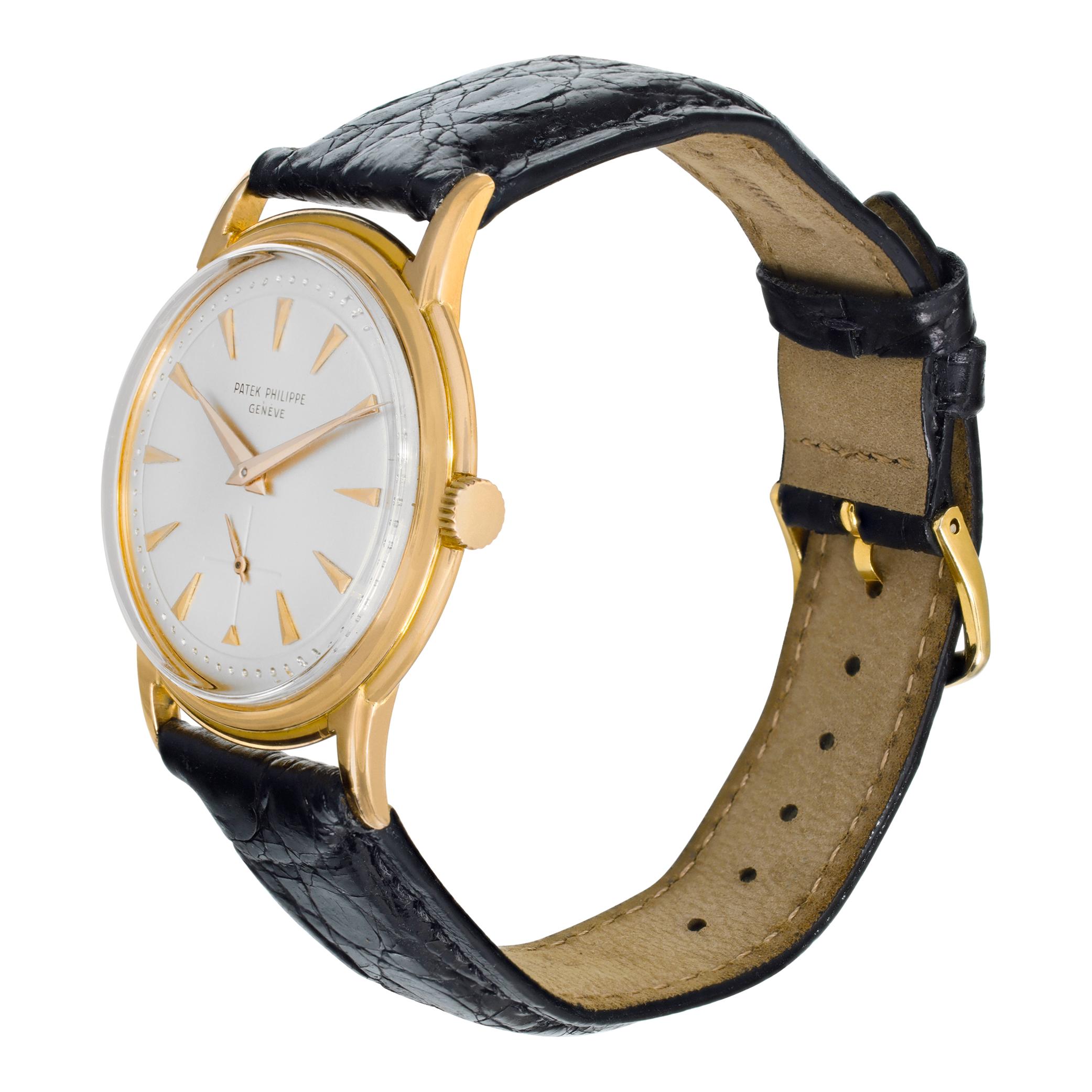 Patek Philippe Calatrava in 18k rose gold on a black alligator strap. Featuring unique silver dial with triangular gold applied markers. The 2525-1 was launched in 1953 with only 300 examples made in yellow gold with a screw on caseback. With