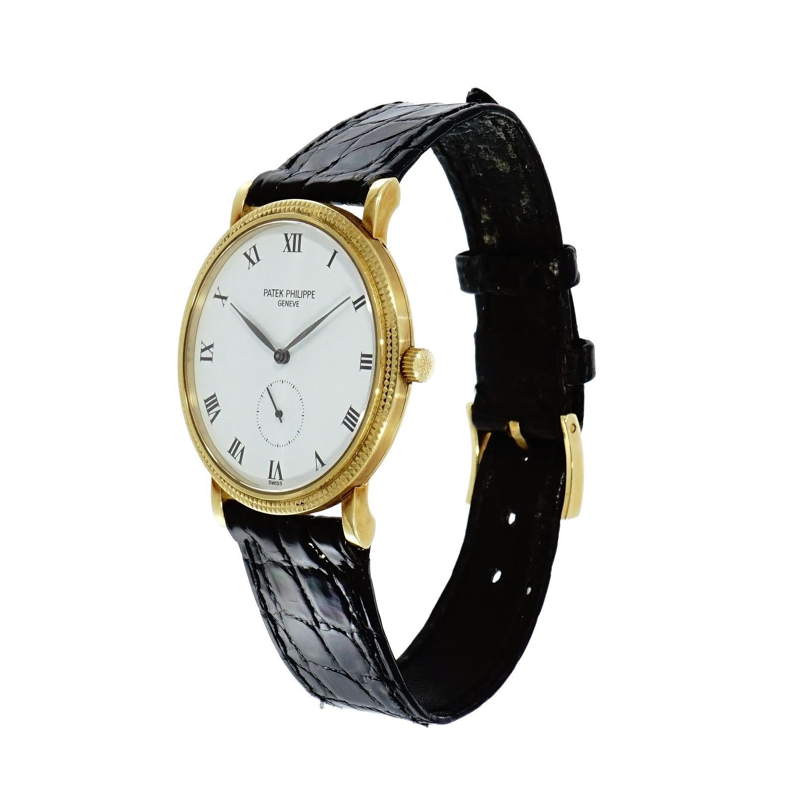 Pre-owned in good condition Patek Philippe Calatrava, 33mm yellow gold case with Hobnail  Bezel, white dial enamel dial with painted black roman numerals hour markers, small seconds at 6 o’clock, manual wound movement, caliber 215, sapphire crystal,