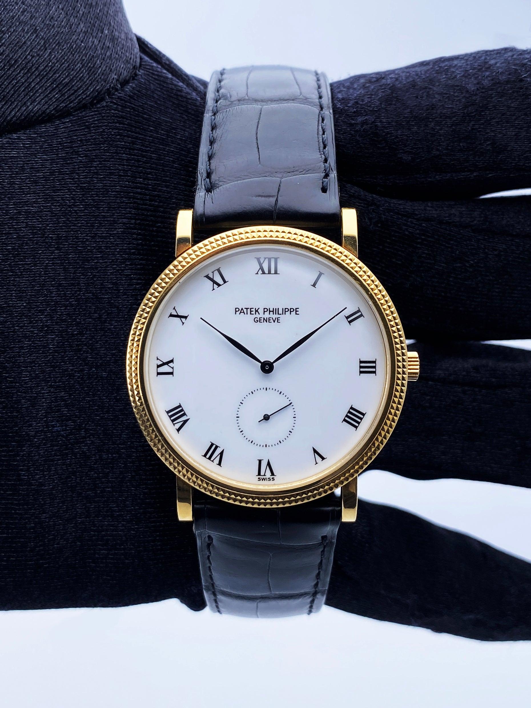 Patek Philippe Calatrava 3919J Mens Watch. 34mm 18K yellow gold case with 18K yellow gold hobnail patterned bezel. White dial with black hands and Roman numeral hour marker. Small second sub-dial display between 5 & 7 o'clock position.