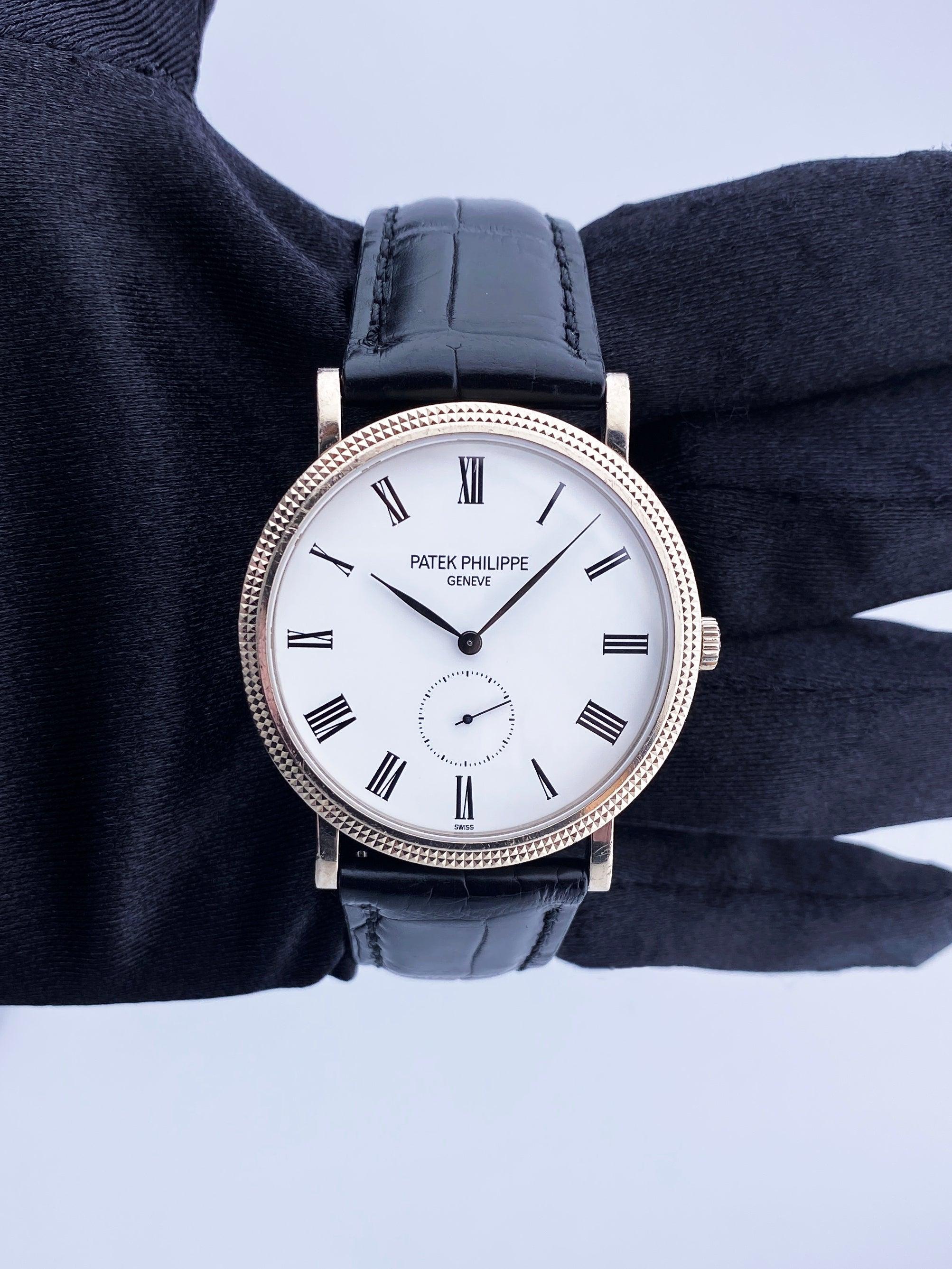 Patek Philippe Calatrava 5119G-001 Mens Watch. 36mm 18K white gold case. 18K white gold hobnail patterned bezel. White dial with black hands and black Roman numeral hour markers. Small second dial display at 6 o'clock position. Black leather Patek
