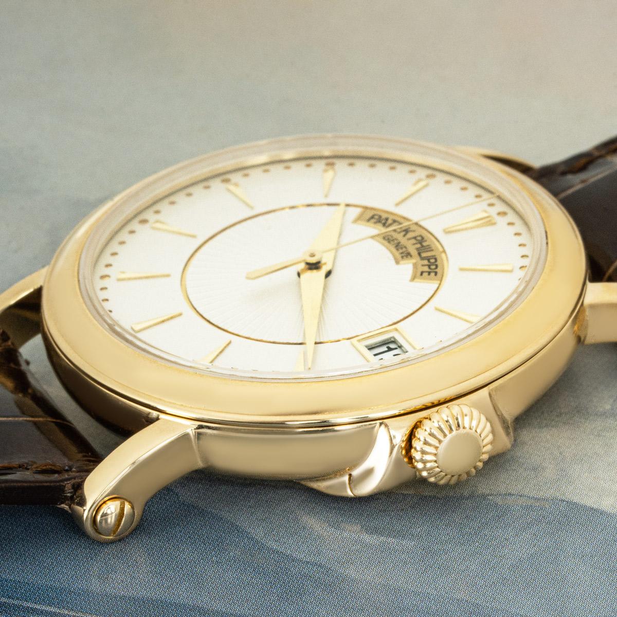 A 38mm Patek Philippe Calatrava crafted in yellow gold. Featuring a silver dial with applied hour markers, a date aperture and yellow gold bezel.

Fitted with a sapphire glass, a self-winding automatic movement and a hinged case back. The watch is