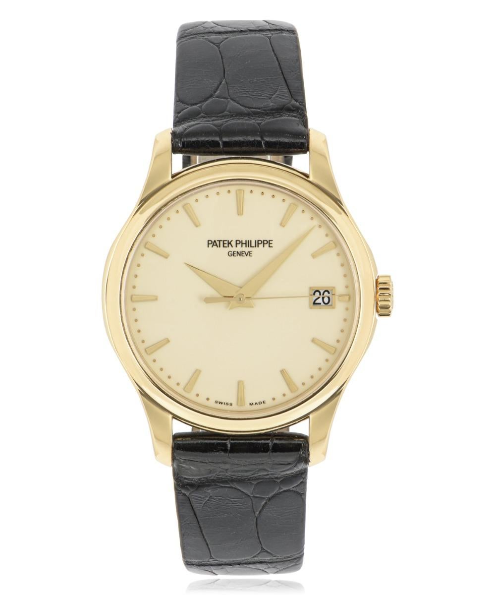As timeless as ever, a 39mm Calatrava in yellow gold from Patek Philippe. Featuring an ivory lacquered dial with a centre sweep second hand and a date display at 3 o'clock. The black leather strap is generic and comes with a gold plated pin buckle