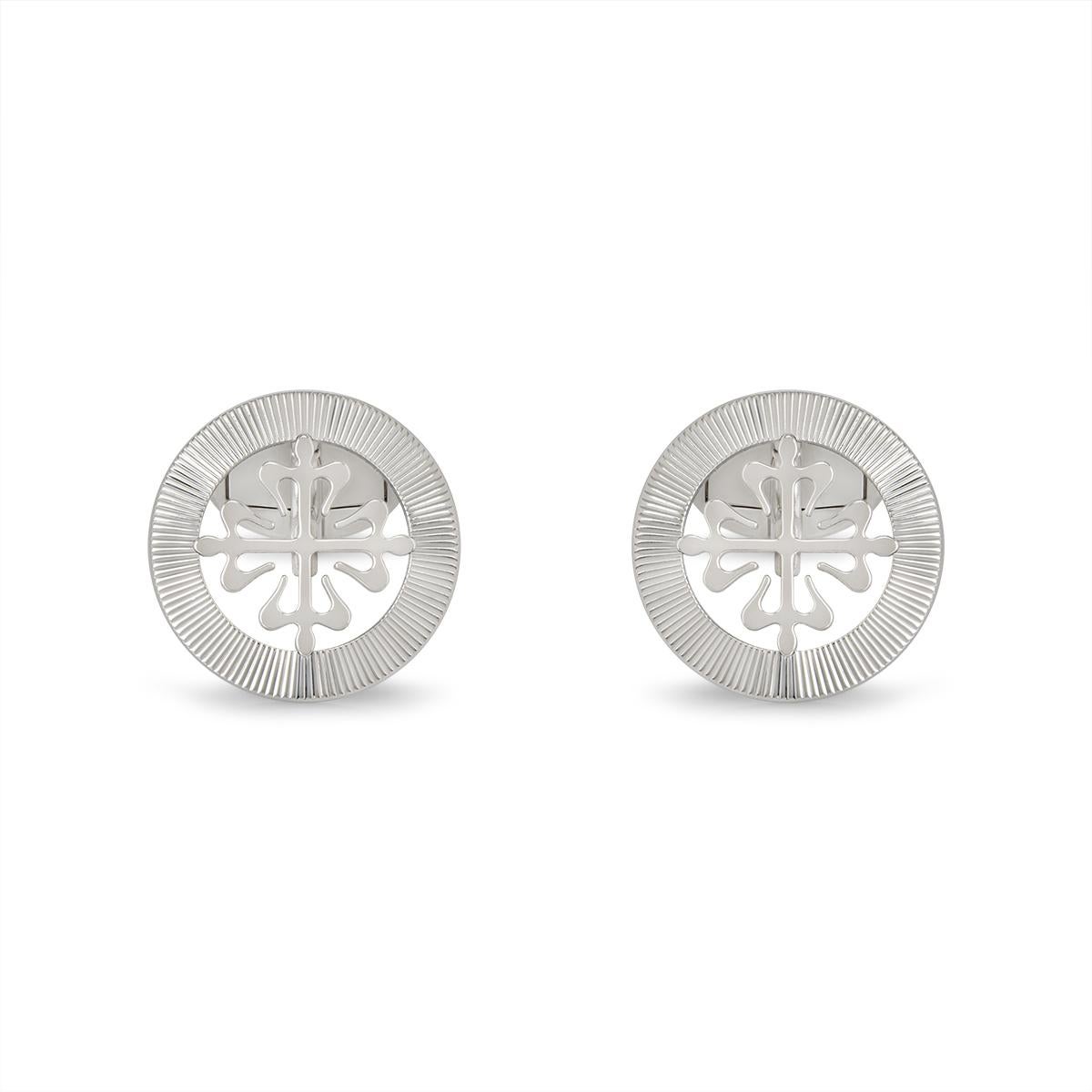 A pair of 18k white gold Calatrava cufflinks by Patek Philippe. The cufflinks feature the classic Calatrava cross motif, surrounded with a guilloche outer edge boarder. The cufflinks have whale back fittings and the motif measures 18mm in diameter.