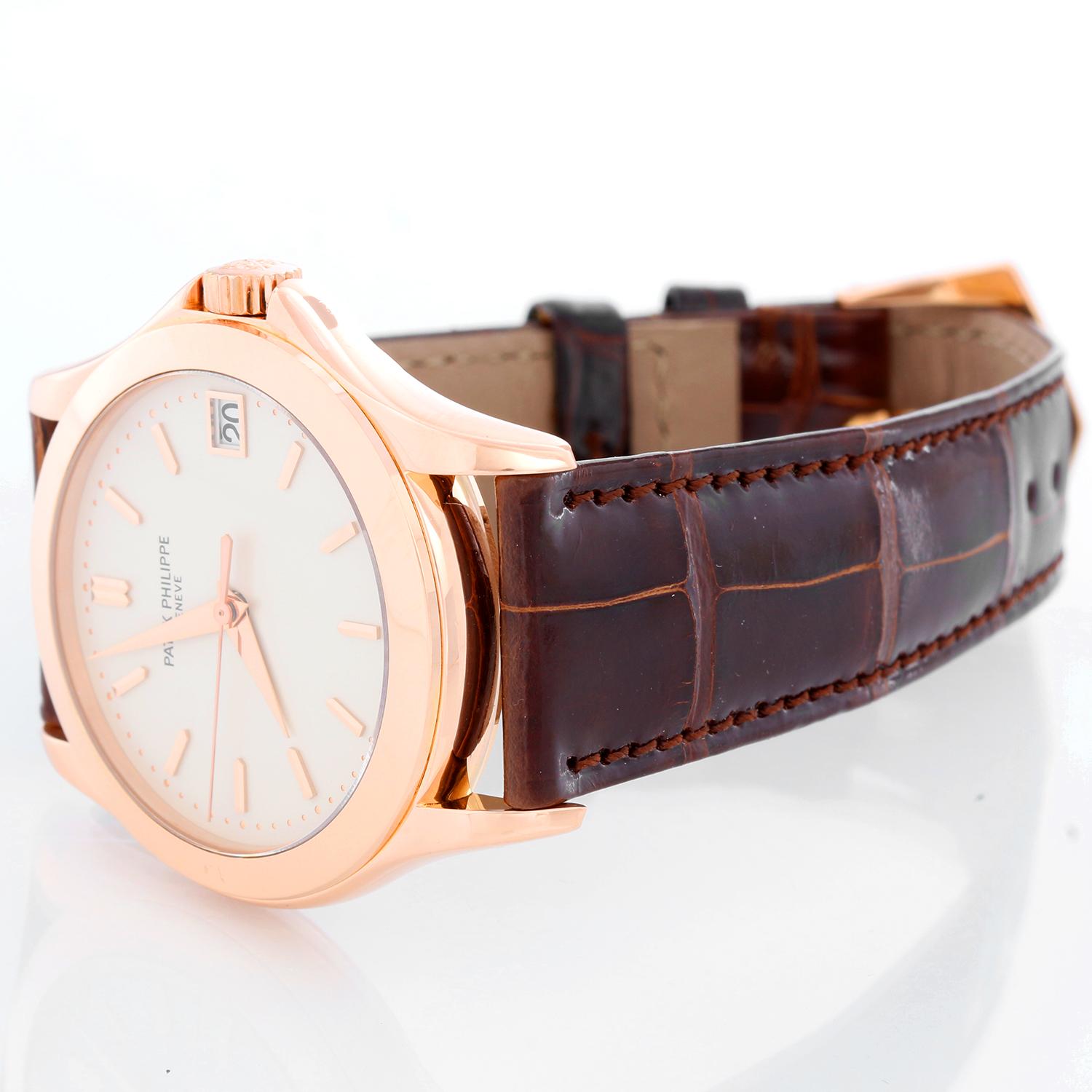 Patek Philippe  Calatrava Men's 18k Rose Gold Watch 315/190 - Automatic winding. 18k Rose gold case with exposition back (37mm diameter). Ivory colored dial with gold stick markers; date at 3 o'clock. Brown alligator strap with tang buckle .