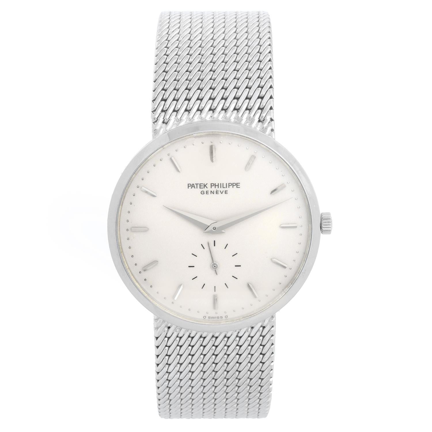 Patek Philippe Calatrava Men's 18k White Gold Watch. Ref. 3893 - Manual winding. 18k white gold case (33mm diameter). Enamel ivory colored dial with gold stick markers; subseconds dial at 6 o'clock position. Integrated 18k yellow gold bracelet. Fits