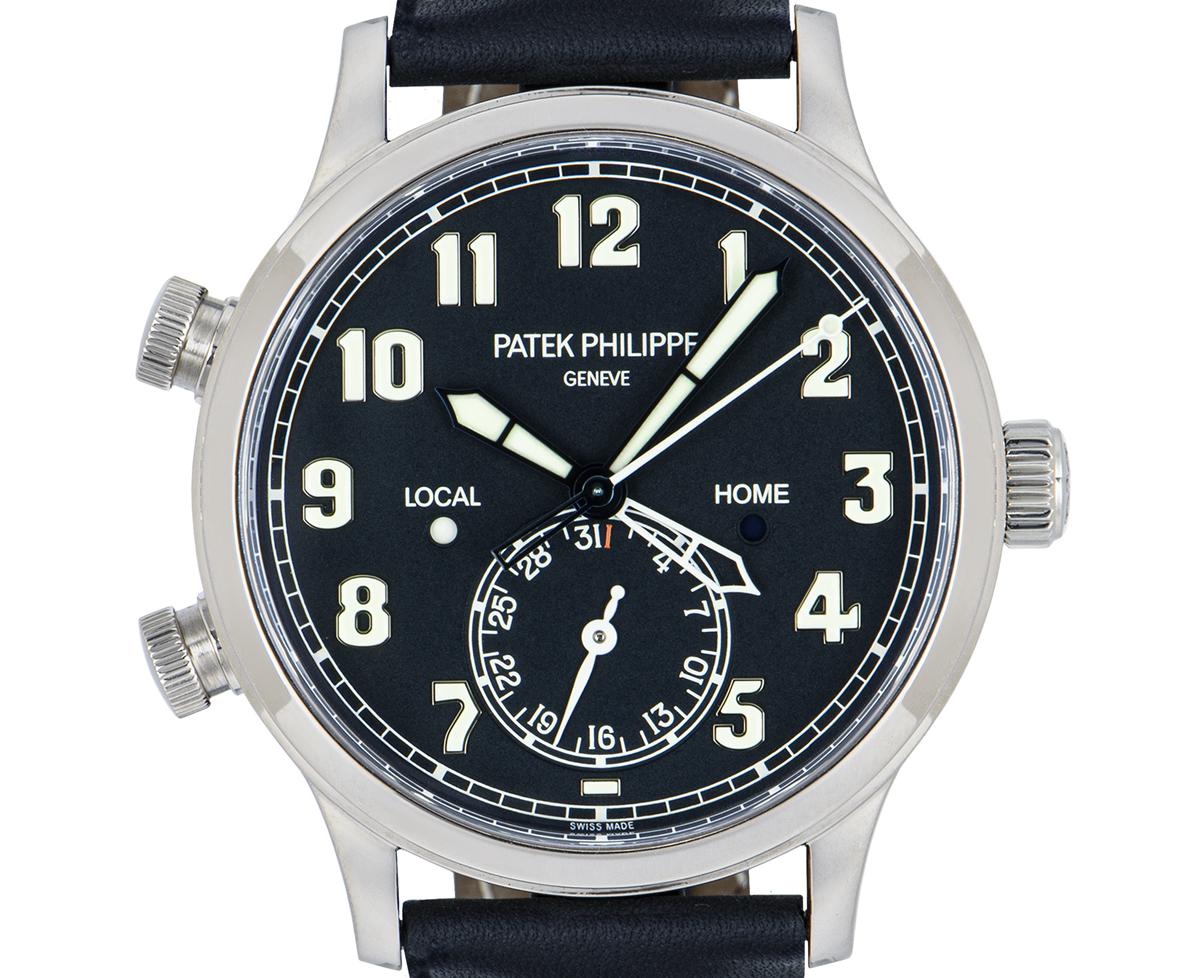 A 42 mm white gold Calatrava Pilot Travel Time with complications by Patek Philippe. Features a blue varnished dial with a second-time zone hand as well as day/night indicators and a date display.

An original brand new brown leather strap (not