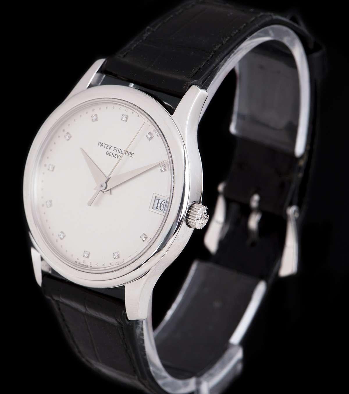A 34mm Platinum Calatrava Gents Wristwatch, rare silver dial with 11 applied round brilliant cut diamond hour markers, date at 3 0'clock, a fixed platinum bezel, an original black leather strap with an original platinum pin buckle, sapphire glass,